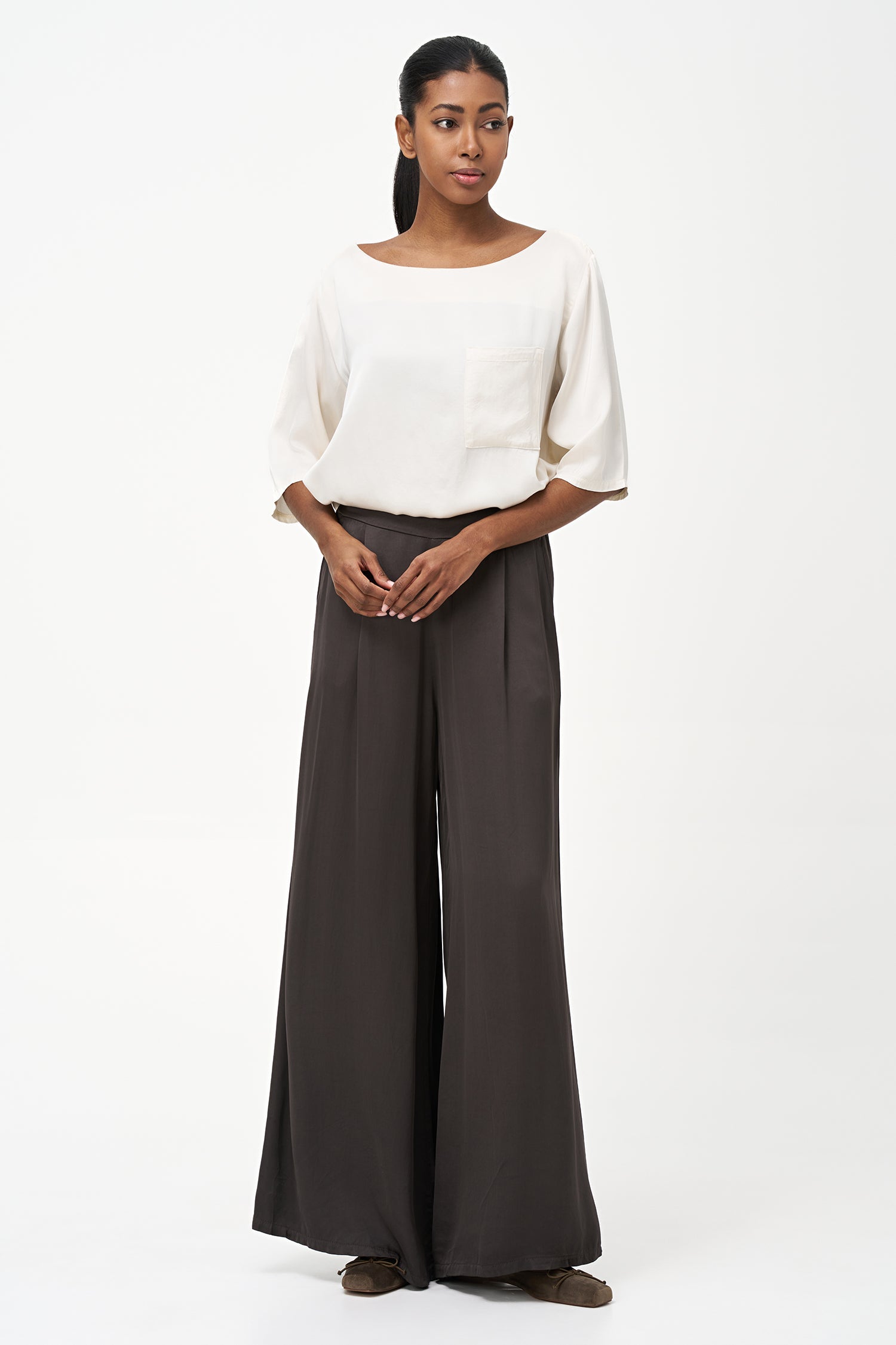 Women’s woven boat-neck top, with elbow length sleeves and a pocket at the chest