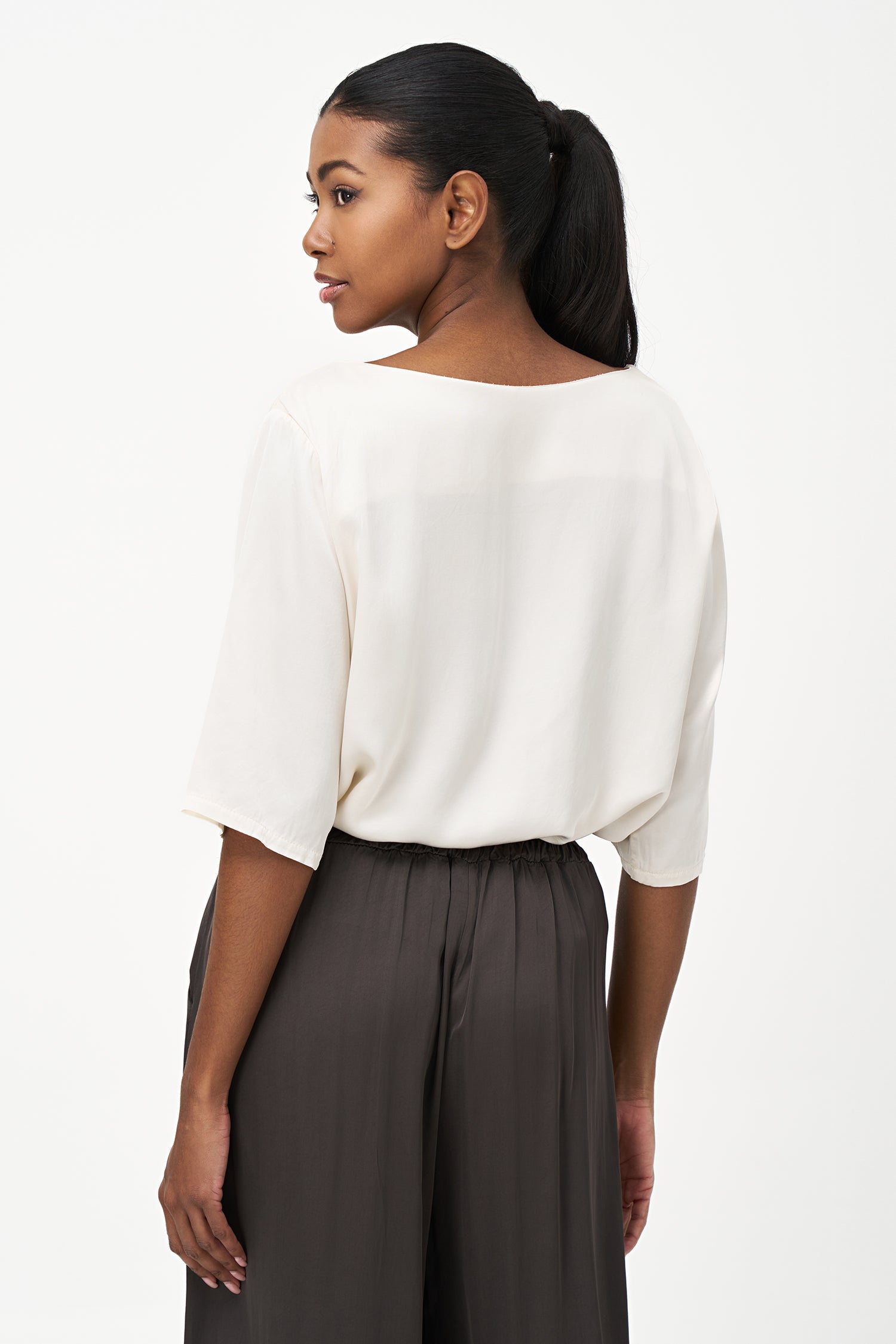 Women’s woven boat-neck top, with elbow length sleeves and a pocket at the chest