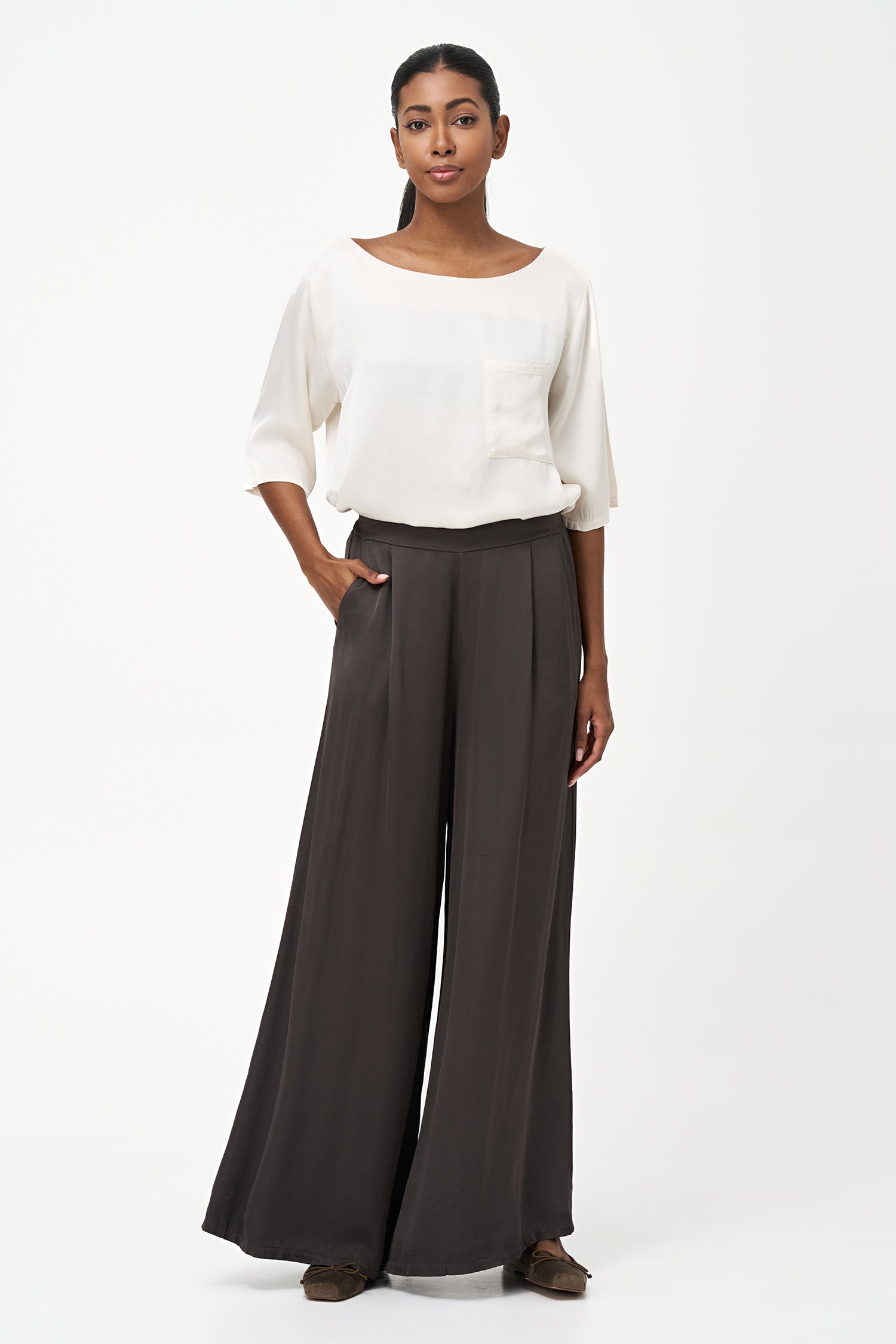 Women’s woven boat-neck top, with elbow length sleeves and a pocket at the chest