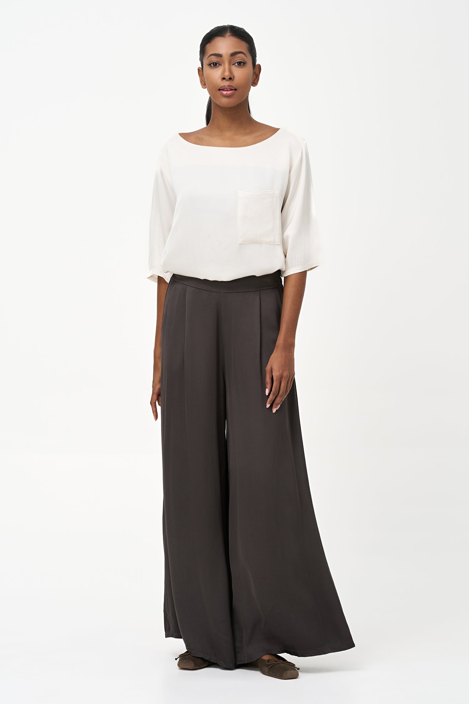 Women’s woven boat-neck top, with elbow length sleeves and a pocket at the chest