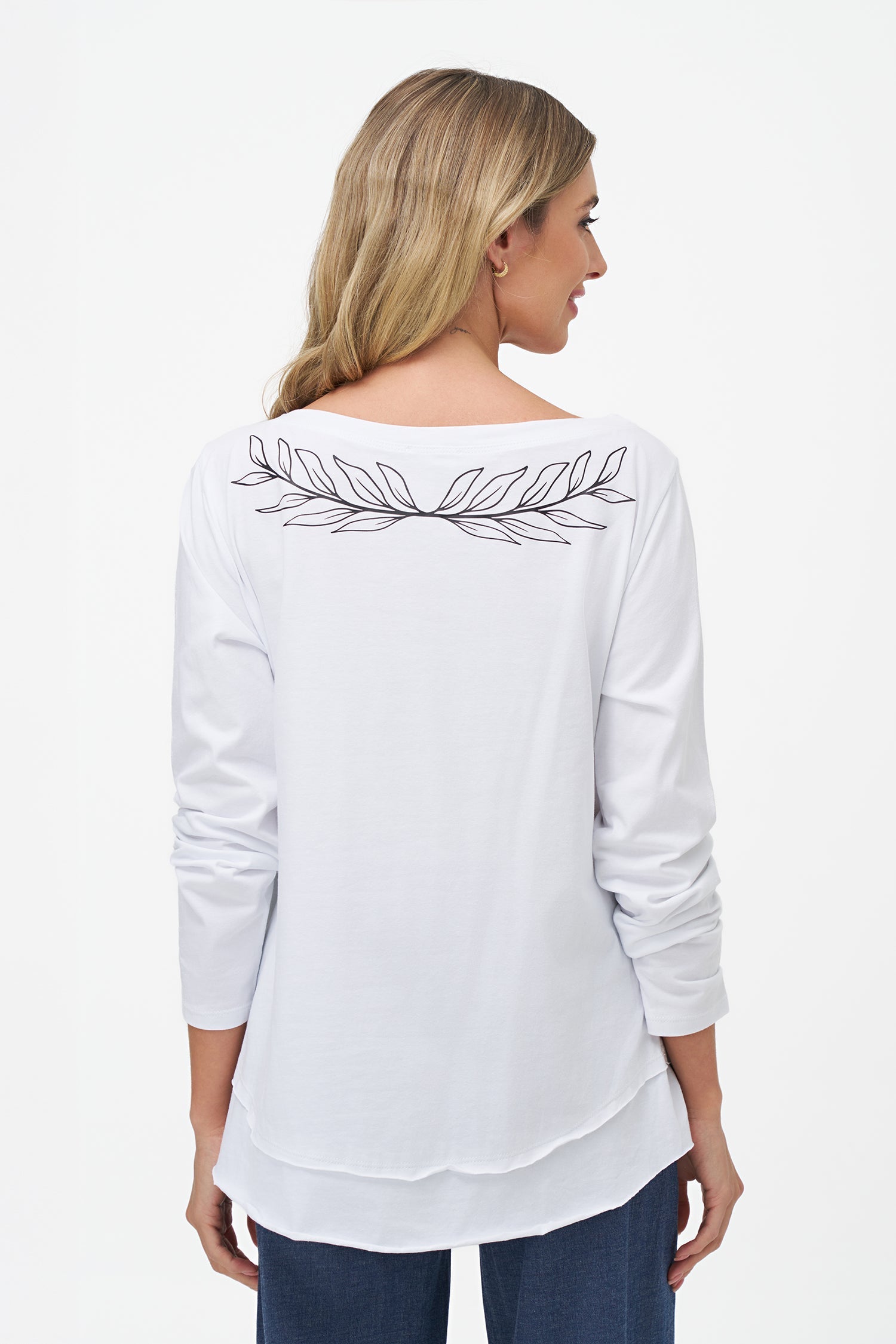 Women's knit boat-neckline long sleeve top, with a front scooped uneven hemline and  a placement print