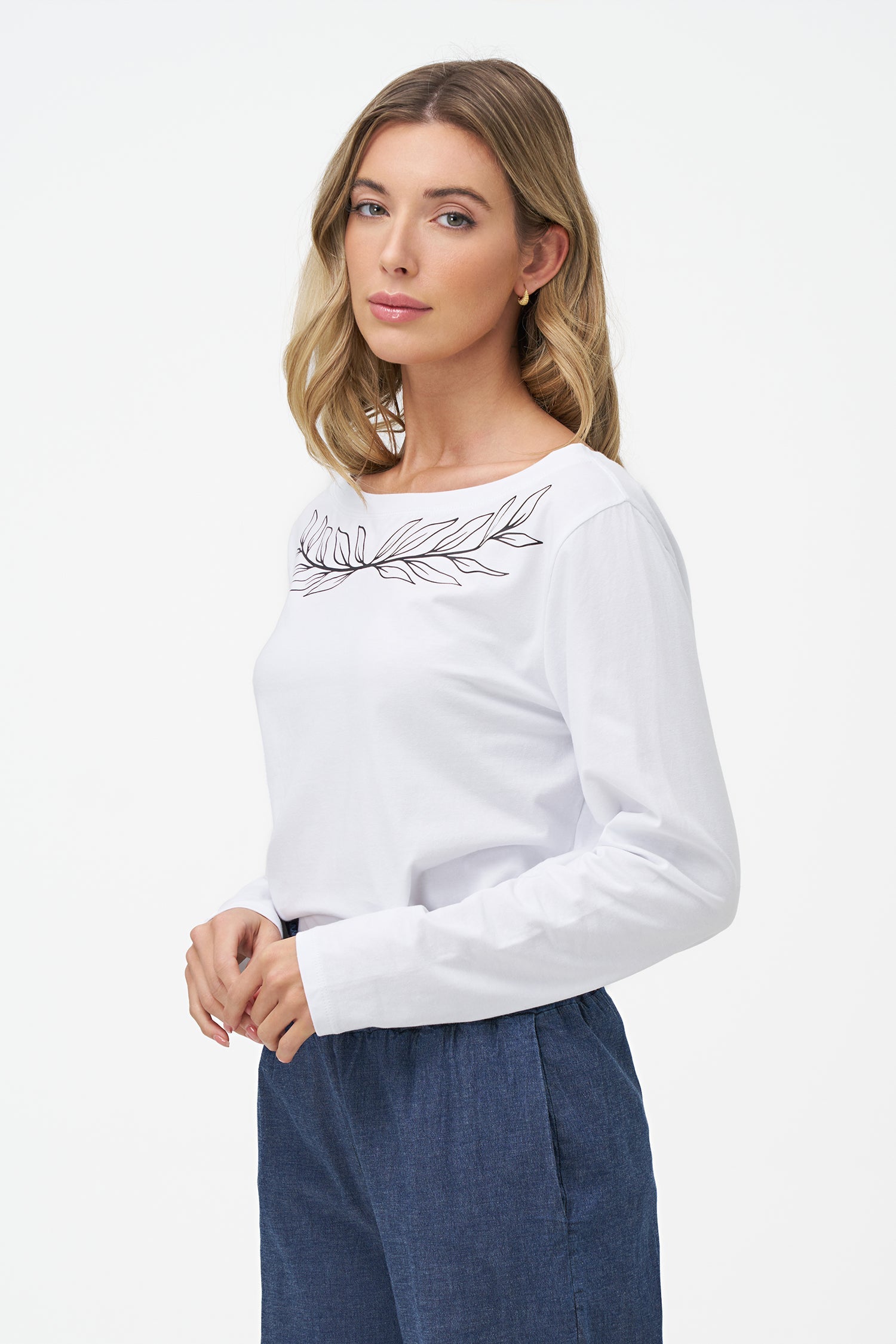 Women's knit boat-neckline long sleeve top, with a front scooped uneven hemline and  a placement print