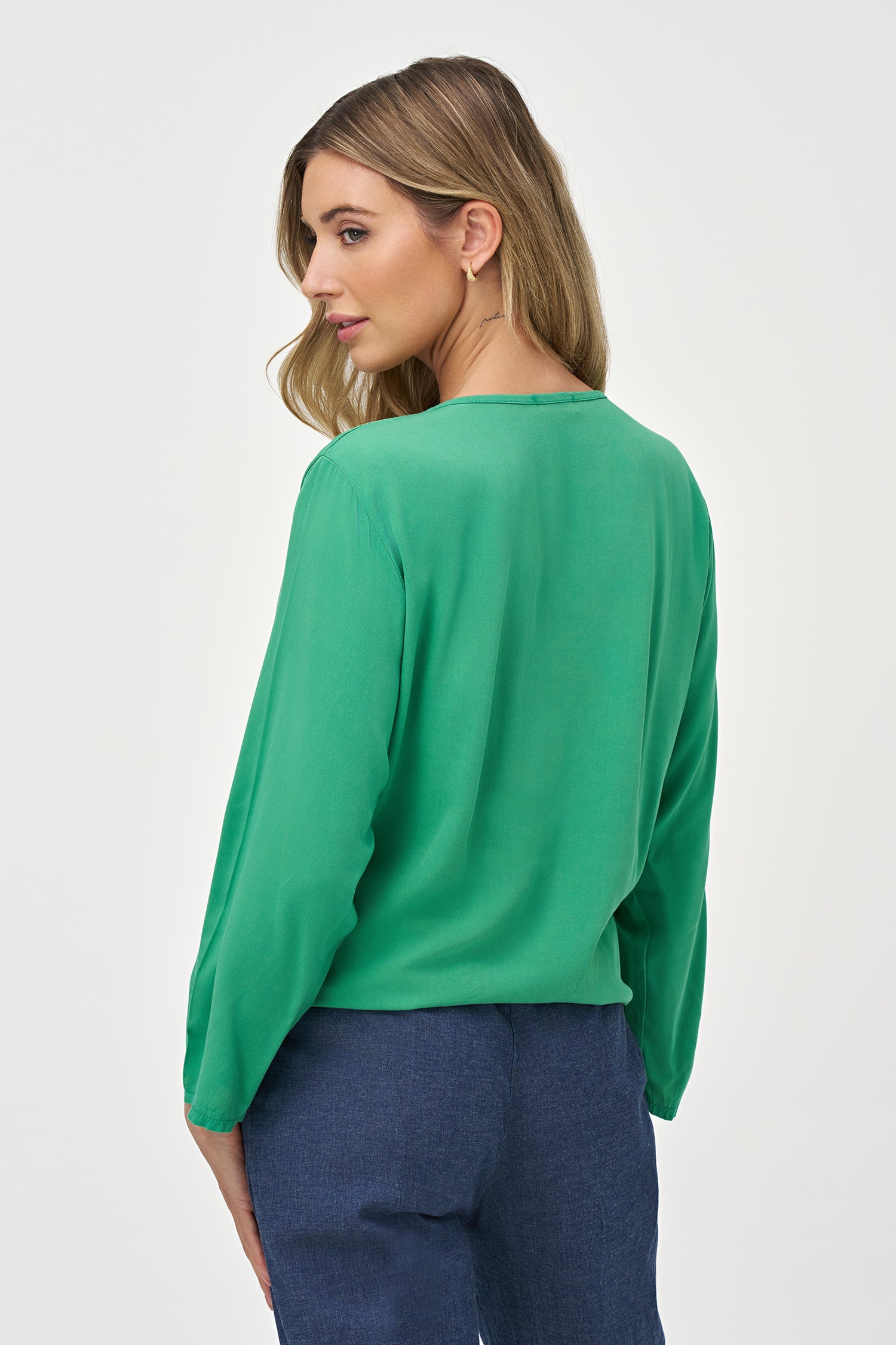 Women’s woven v-neck top, with long sleeves and a front tie at the hemline