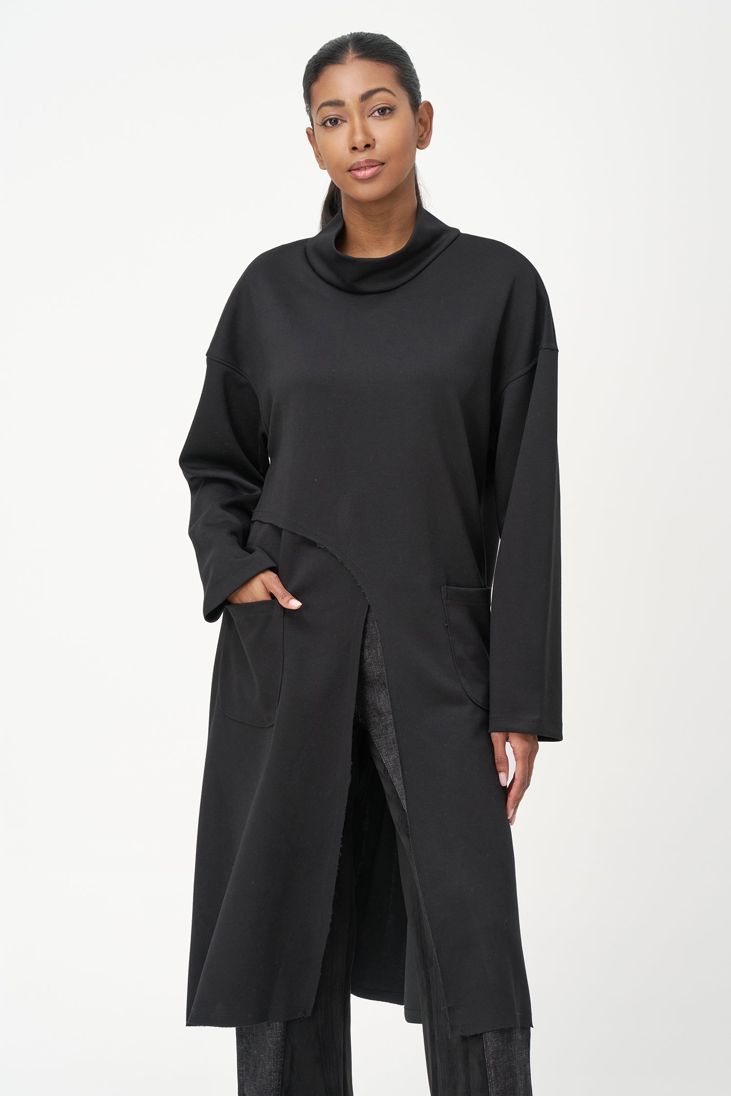 Women’s knit mock-neck tunic, with long sleeves, patch pockets and a front slit opening