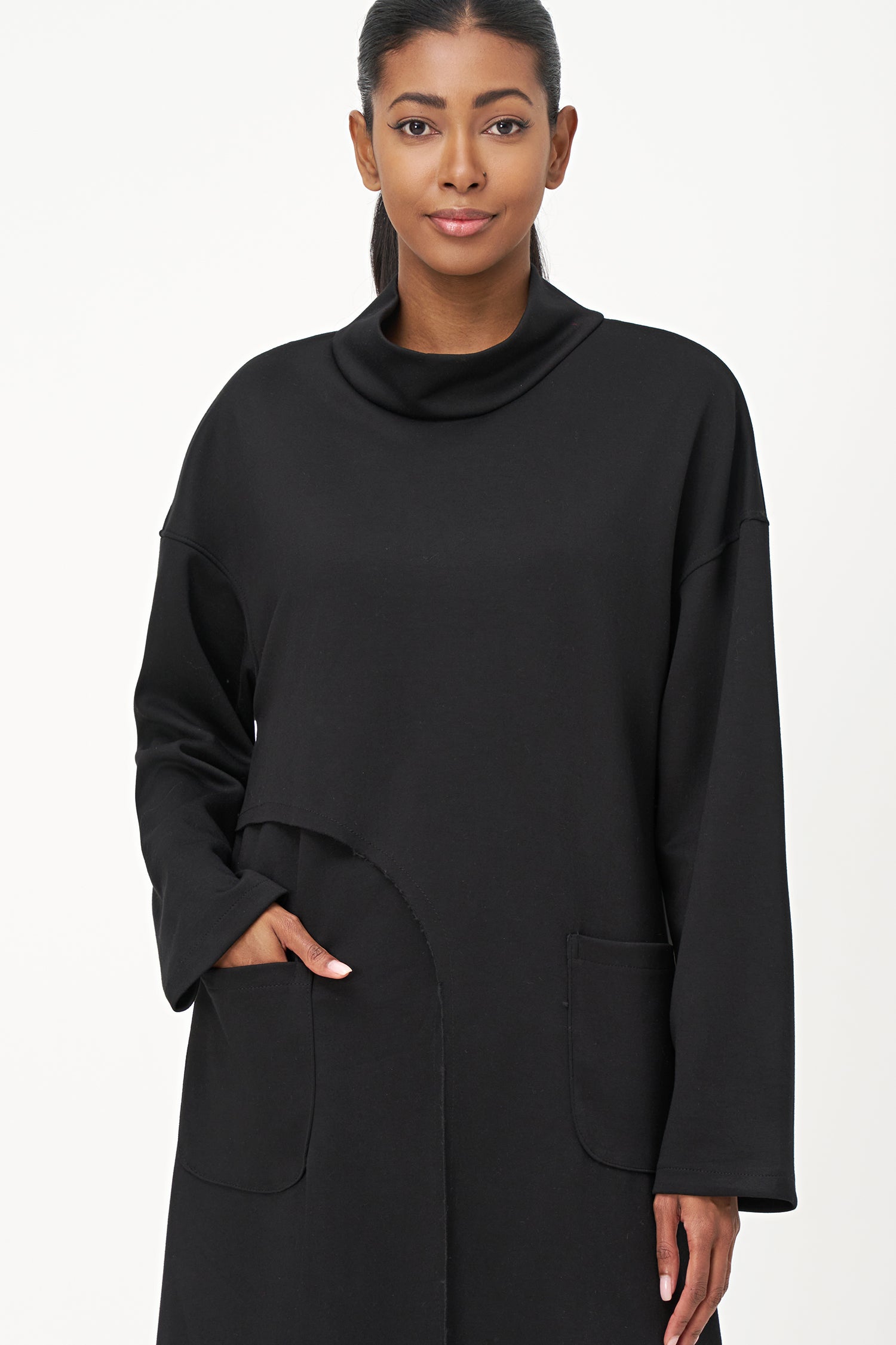 Women’s knit mock-neck tunic, with long sleeves, patch pockets and a front slit opening