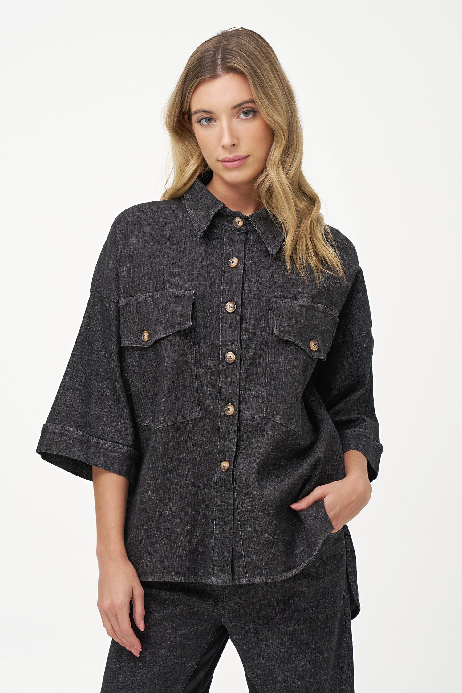 Women's woven denim button-down shirt, with elbow length sleeves and oversized patch pockets