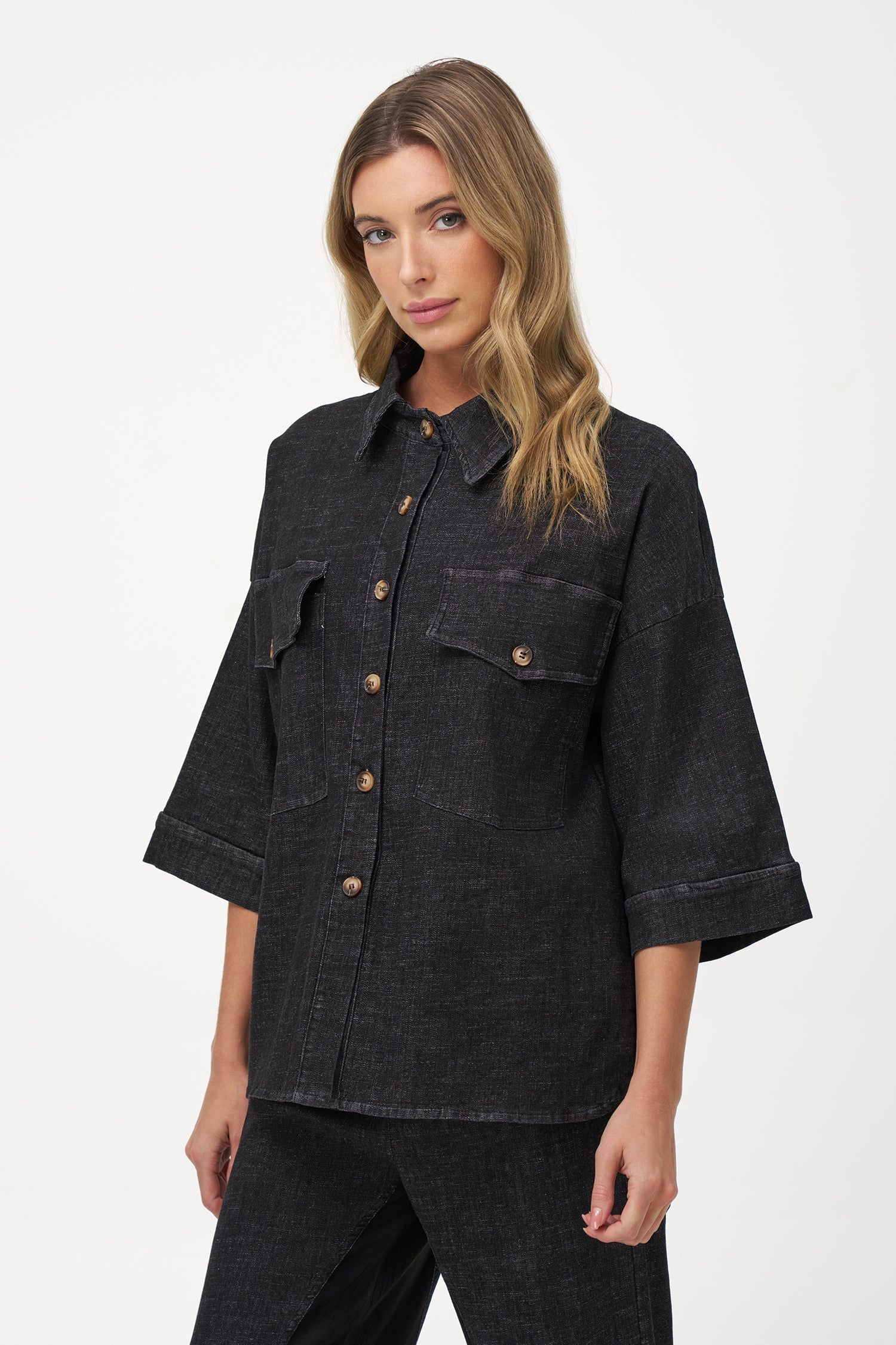 Women's woven denim button-down shirt, with elbow length sleeves and oversized patch pockets