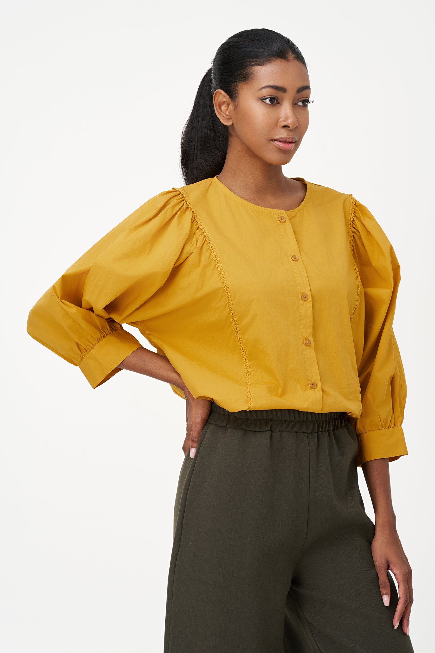 Women’s woven button-down crew-neckline shirt, with long sleeves and trim detailing