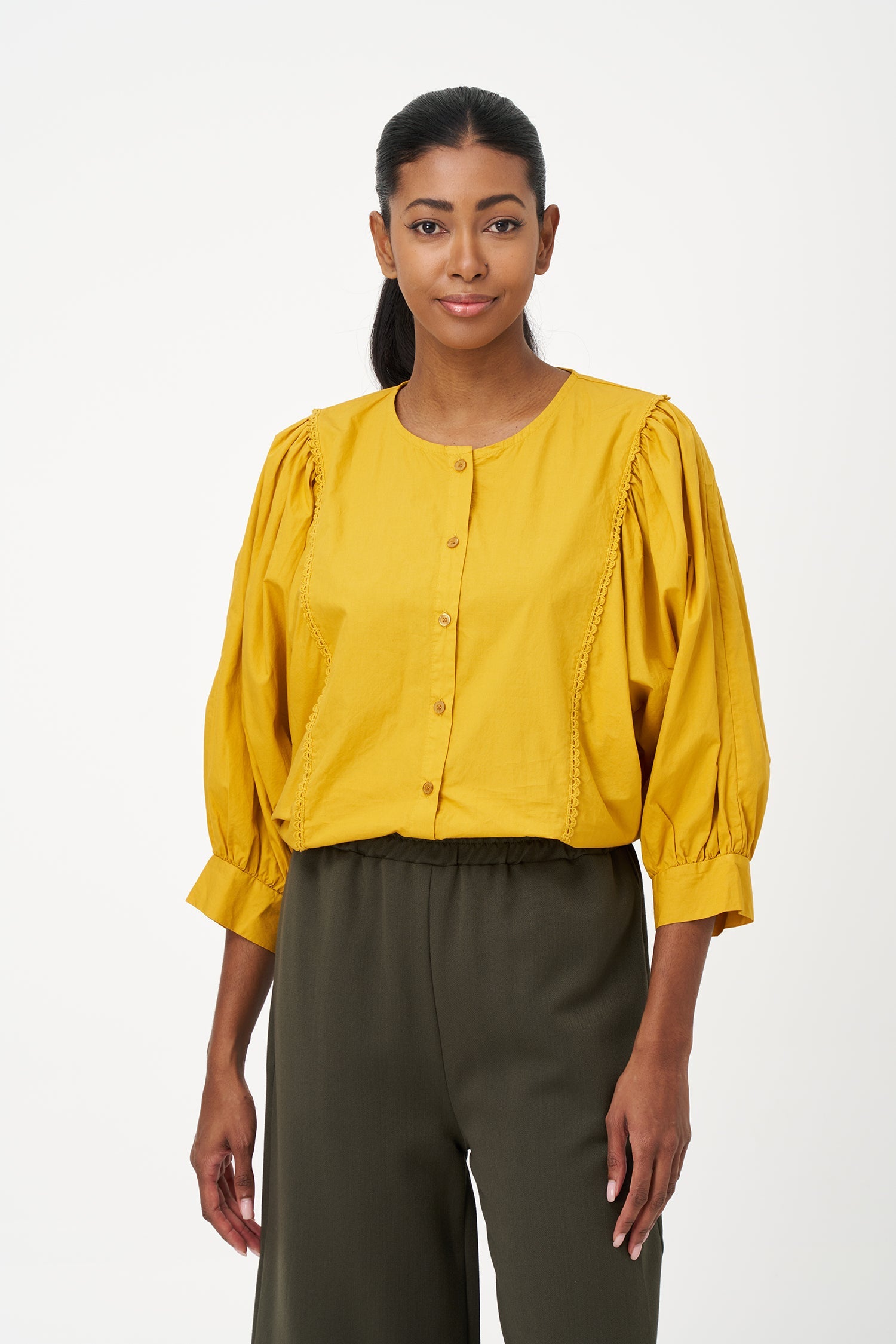 Women’s woven button-down crew-neckline shirt, with long sleeves and trim detailing