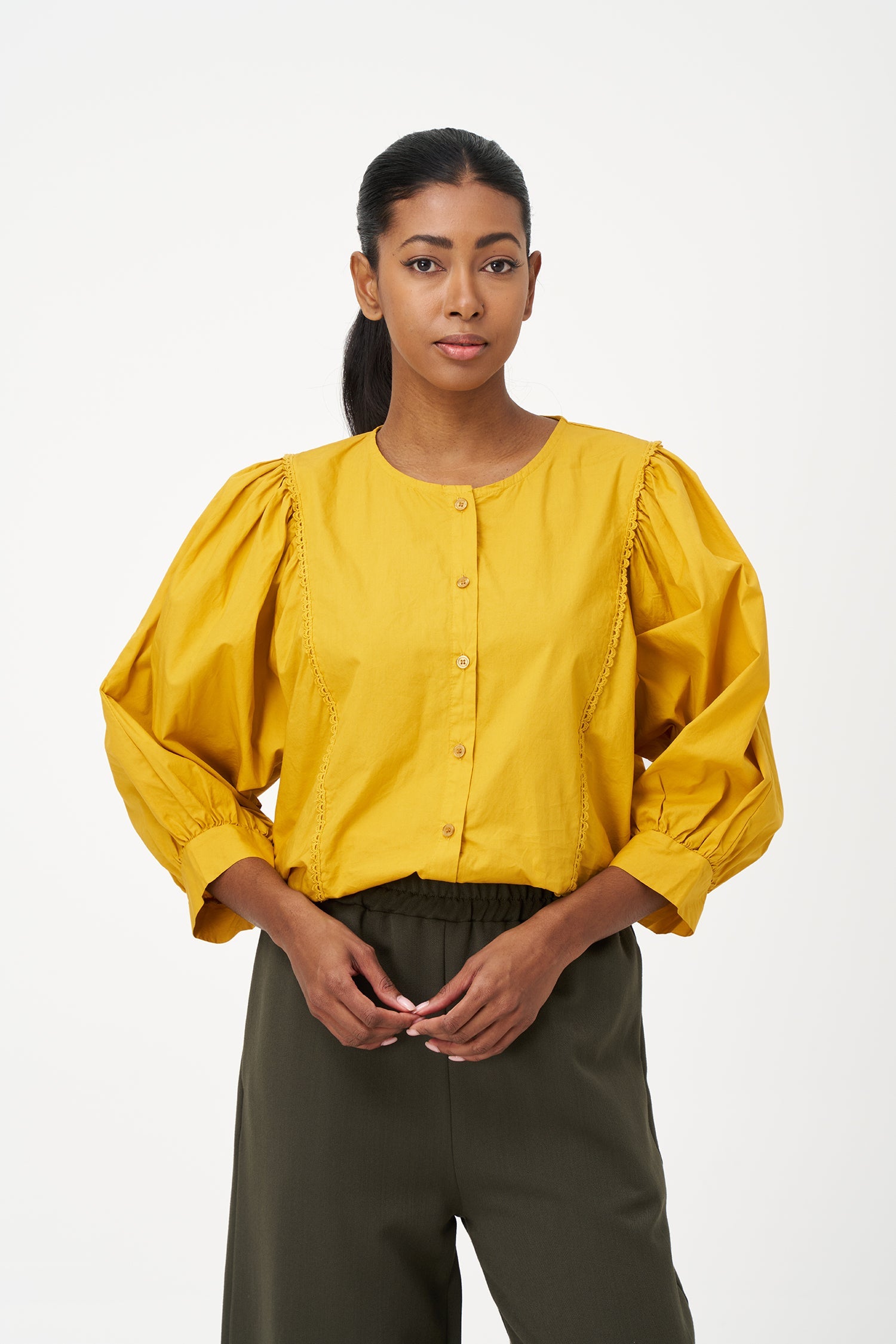Women’s woven button-down crew-neckline shirt, with long sleeves and trim detailing