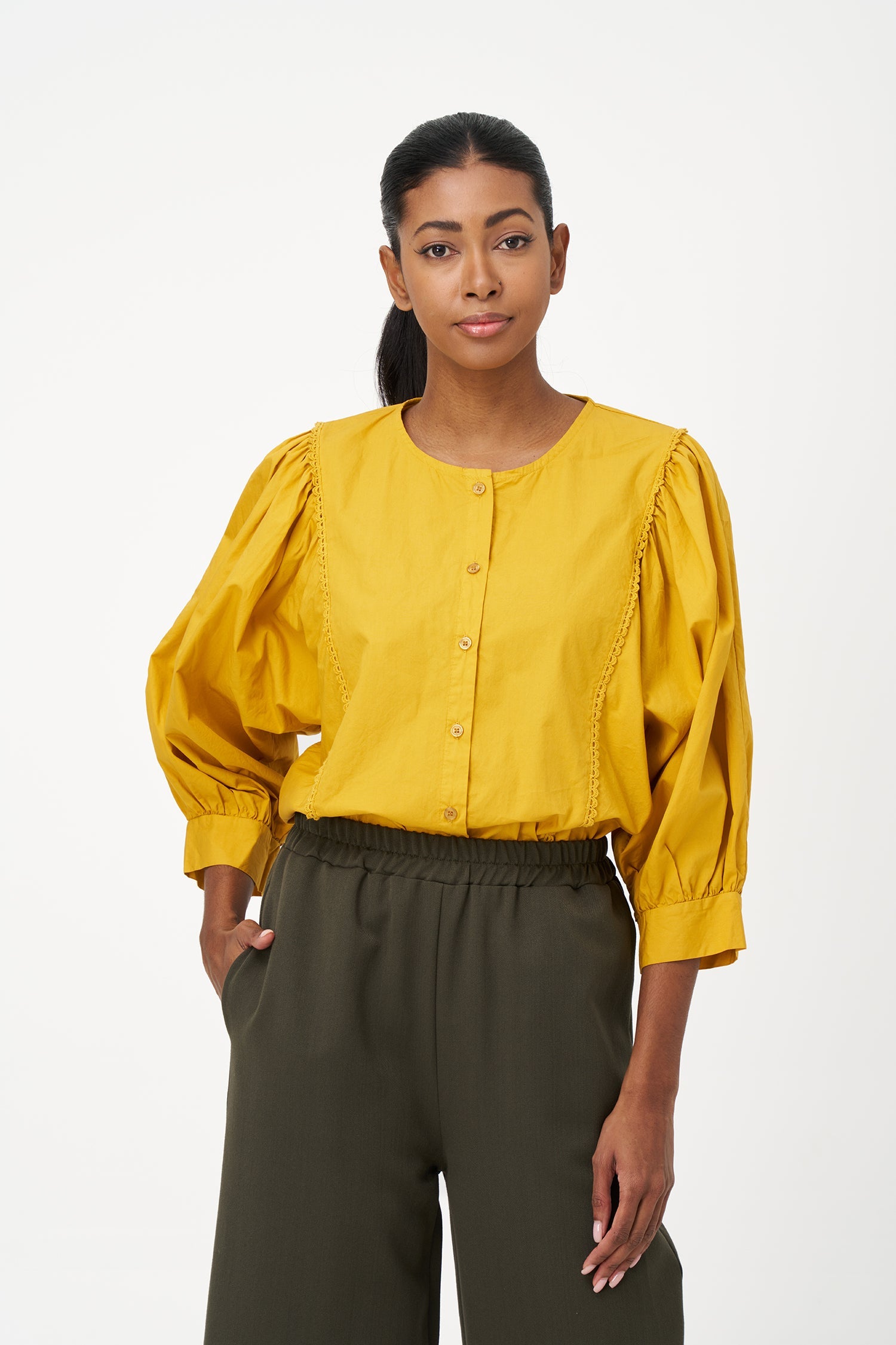 Women’s woven button-down crew-neckline shirt, with long sleeves and trim detailing