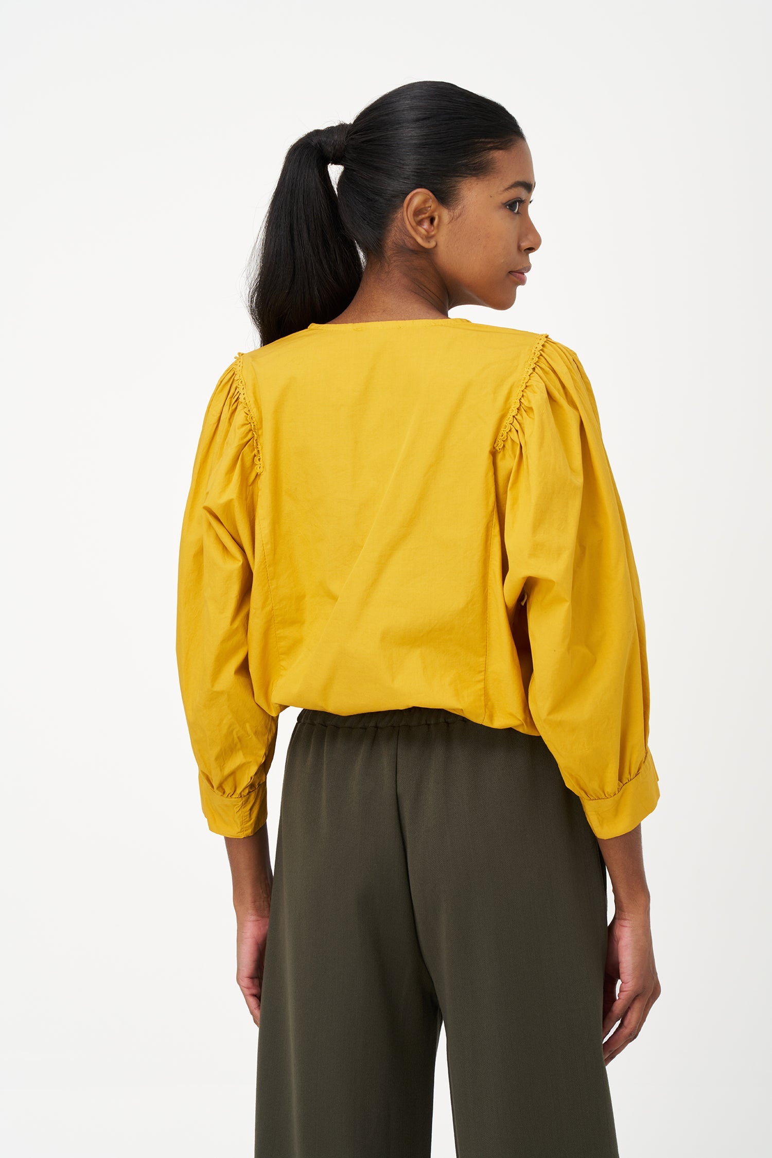 Women’s woven button-down crew-neckline shirt, with long sleeves and trim detailing