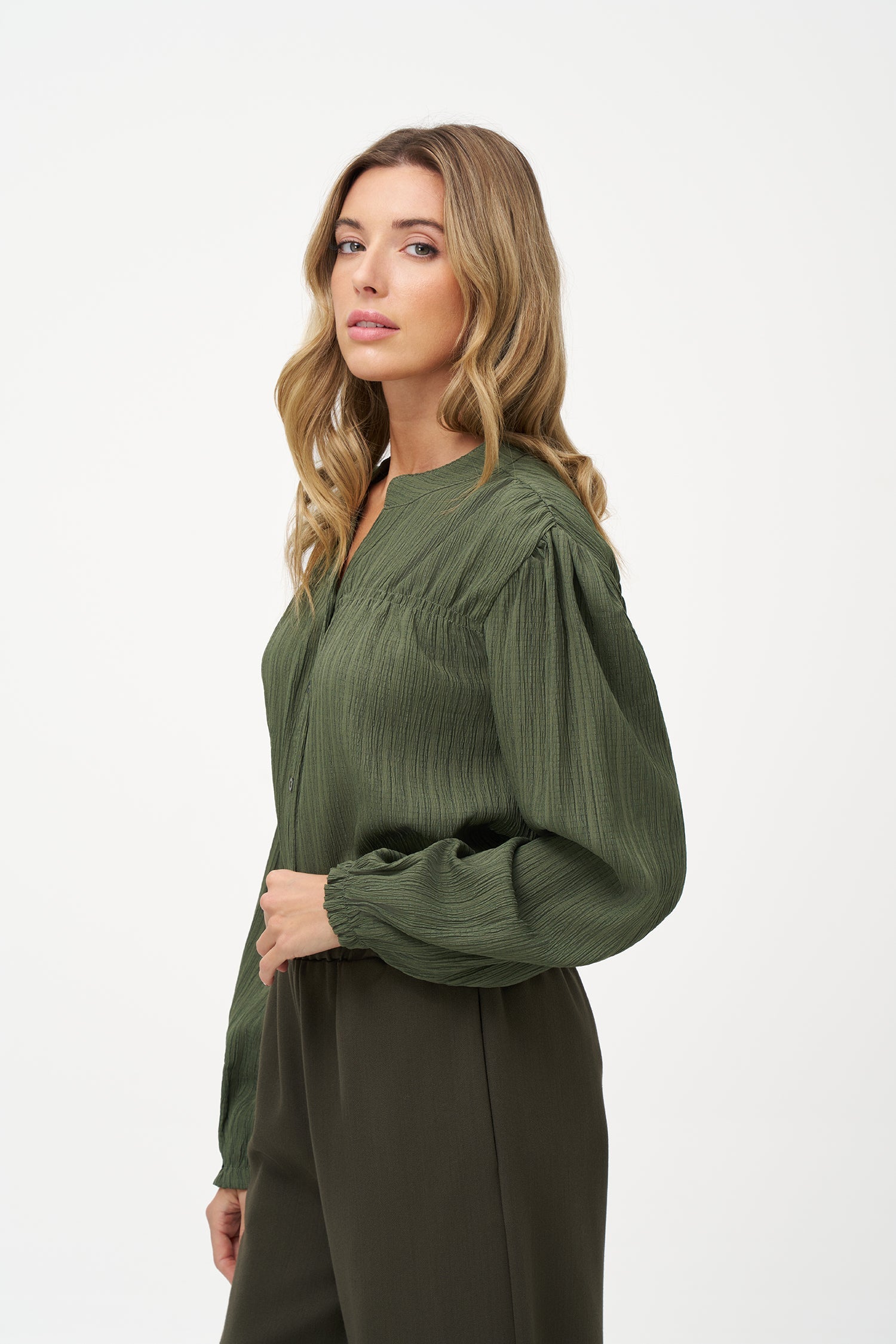 Women's woven button down shirt, with a v-neckline & stand collar, and smocked detailing at the shoulders (front & back)