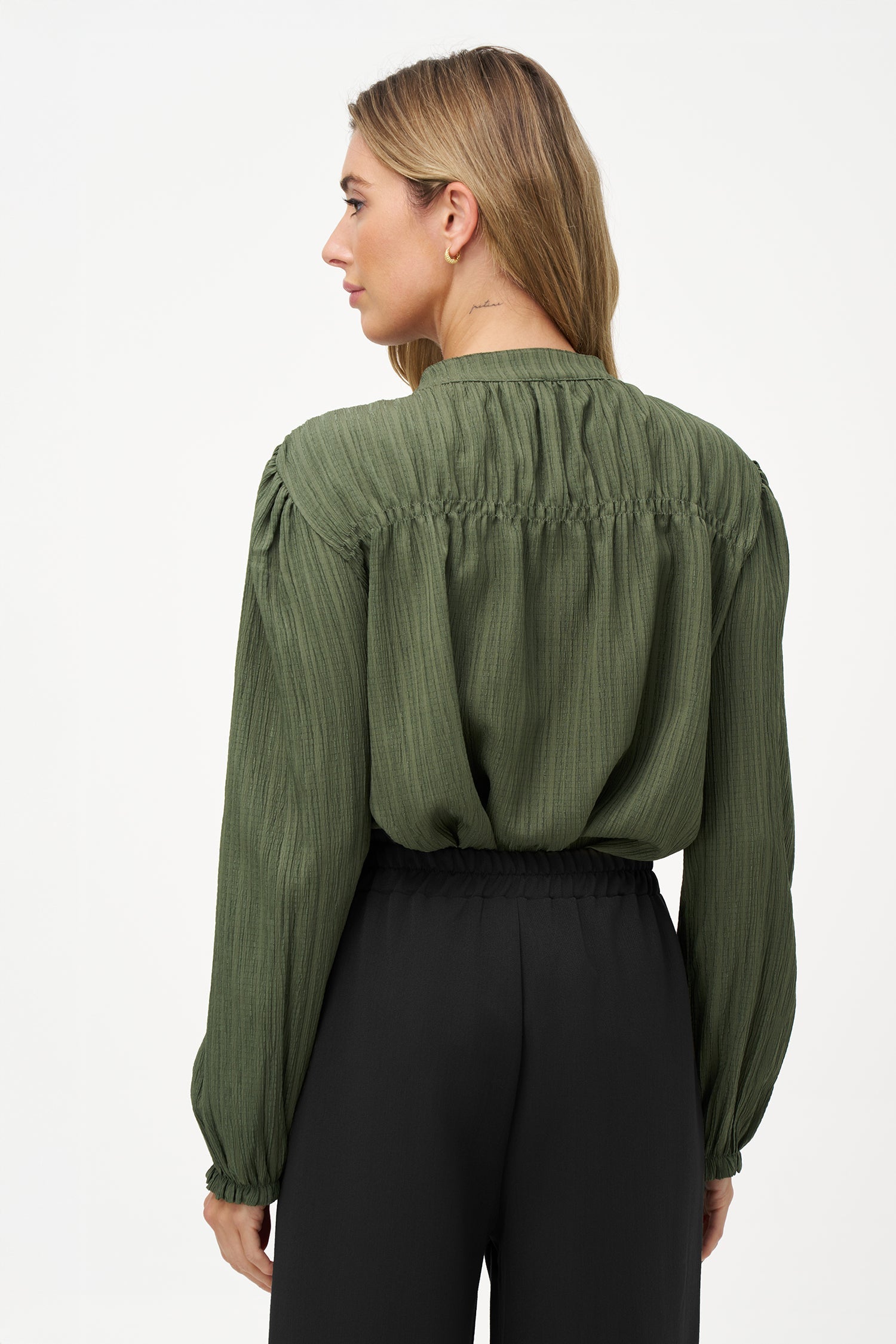 Women's woven button down shirt, with a v-neckline & stand collar, and smocked detailing at the shoulders (front & back)