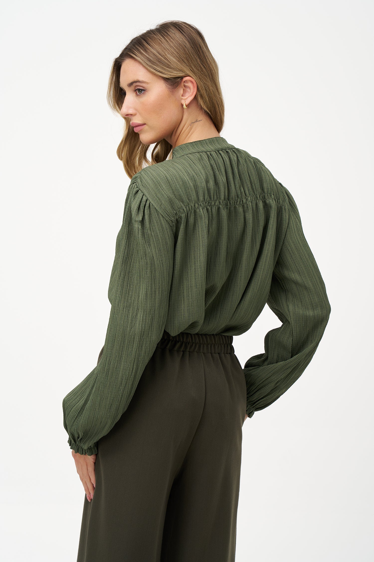 Women's woven button down shirt, with a v-neckline & stand collar, and smocked detailing at the shoulders (front & back)