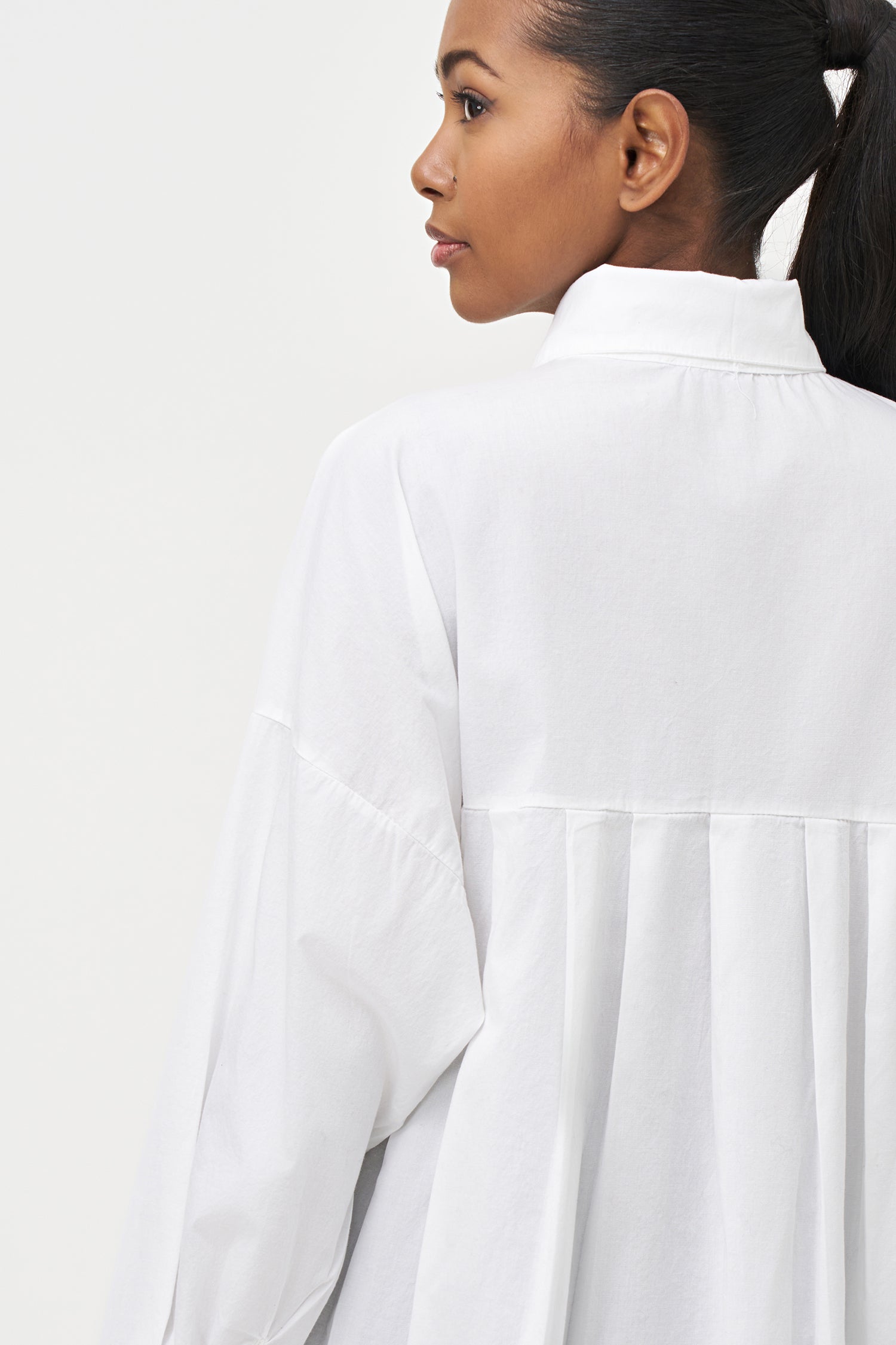 Women's woven button-down long sleeve shirt, with a pleated back detailing