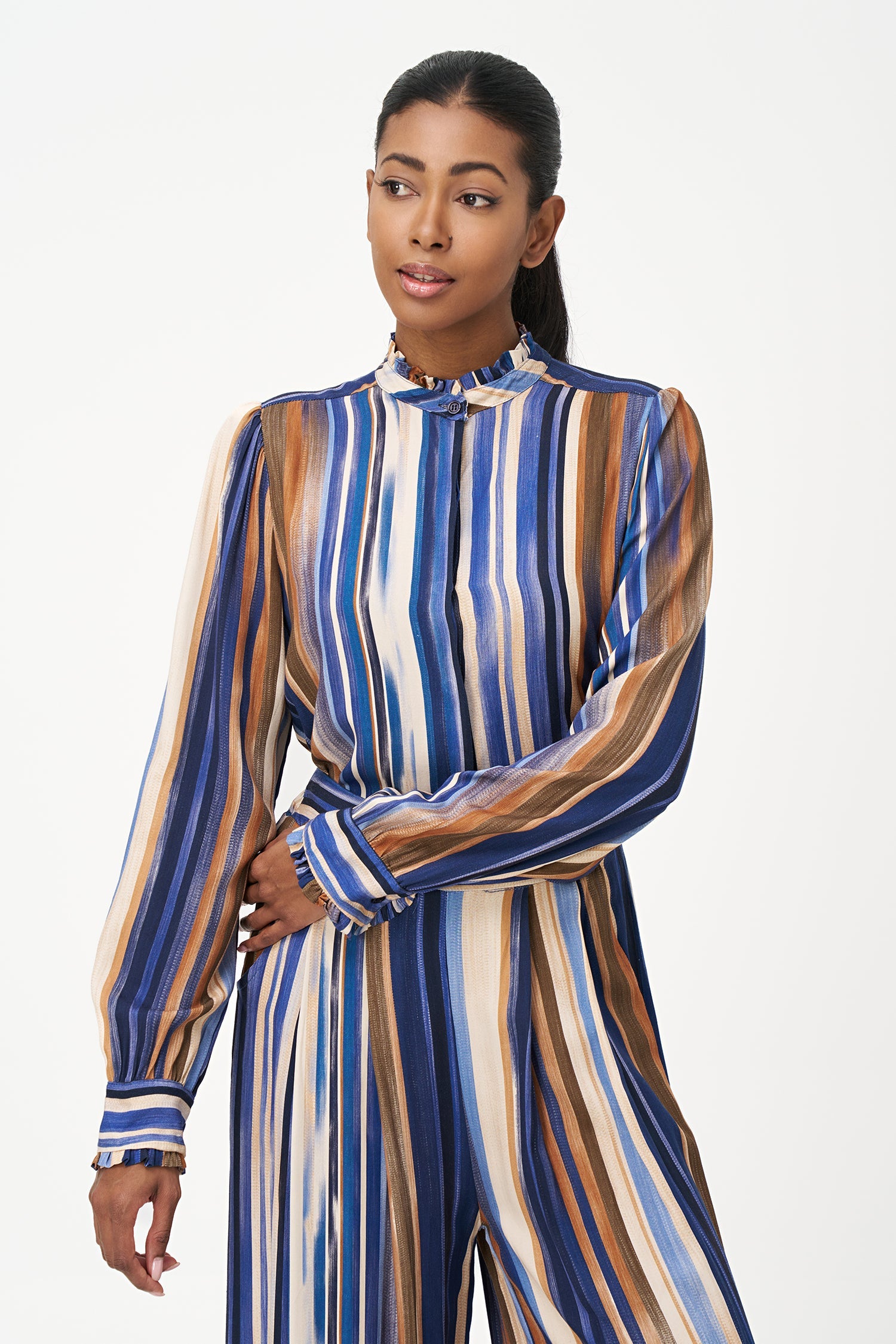 Women’s woven button-down shirt, with long set-in sleeves, a ruffled stand collar and ruffled cuffs