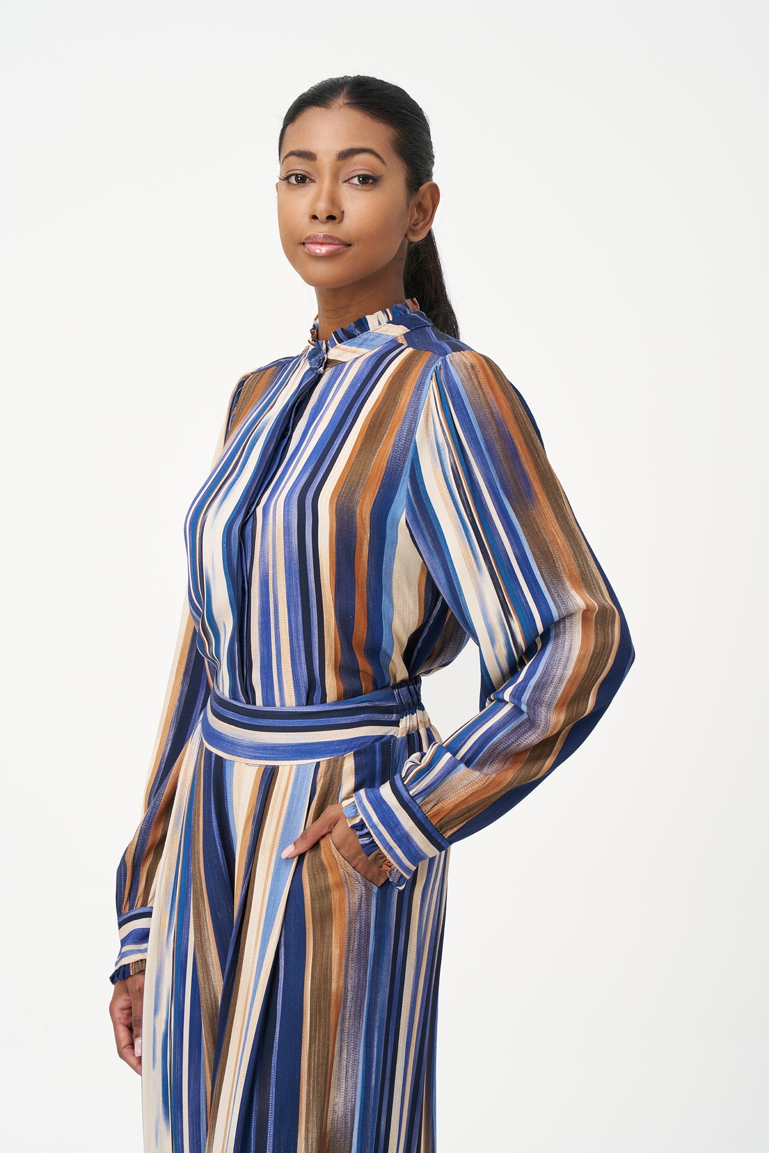 Women’s woven button-down shirt, with long set-in sleeves, a ruffled stand collar and ruffled cuffs