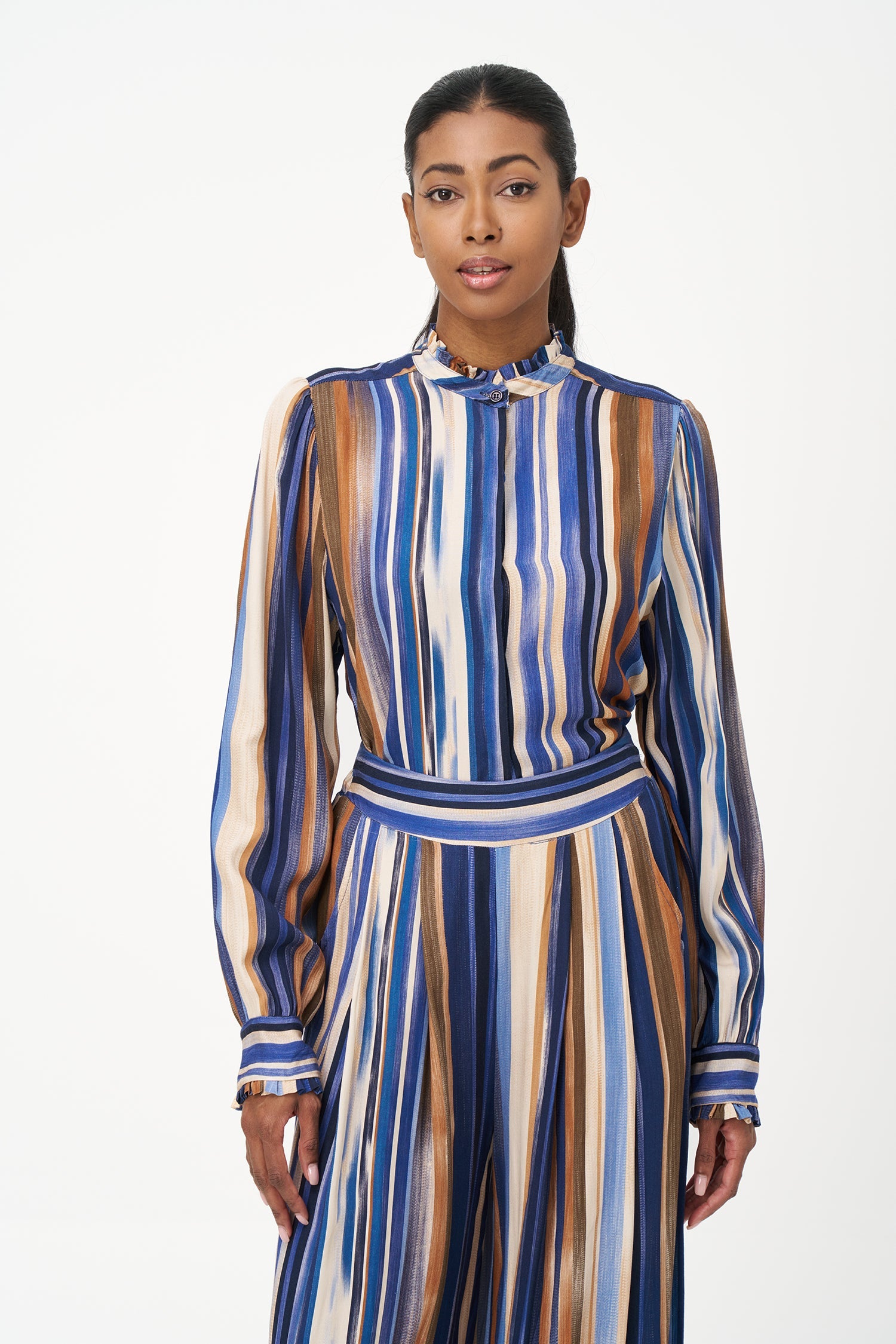 Women’s woven button-down shirt, with long set-in sleeves, a ruffled stand collar and ruffled cuffs