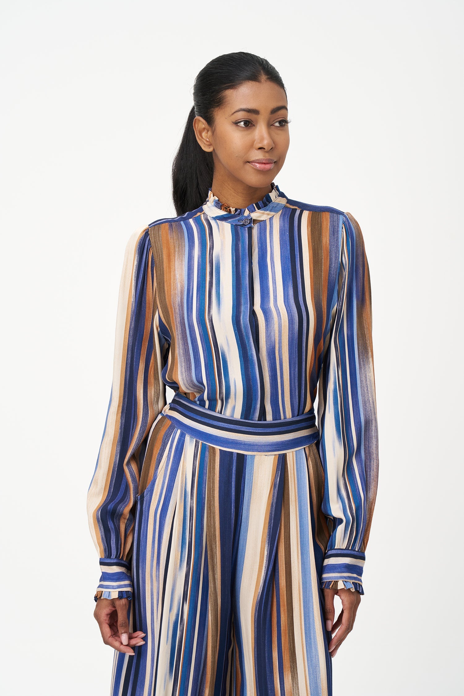 Women’s woven button-down shirt, with long set-in sleeves, a ruffled stand collar and ruffled cuffs