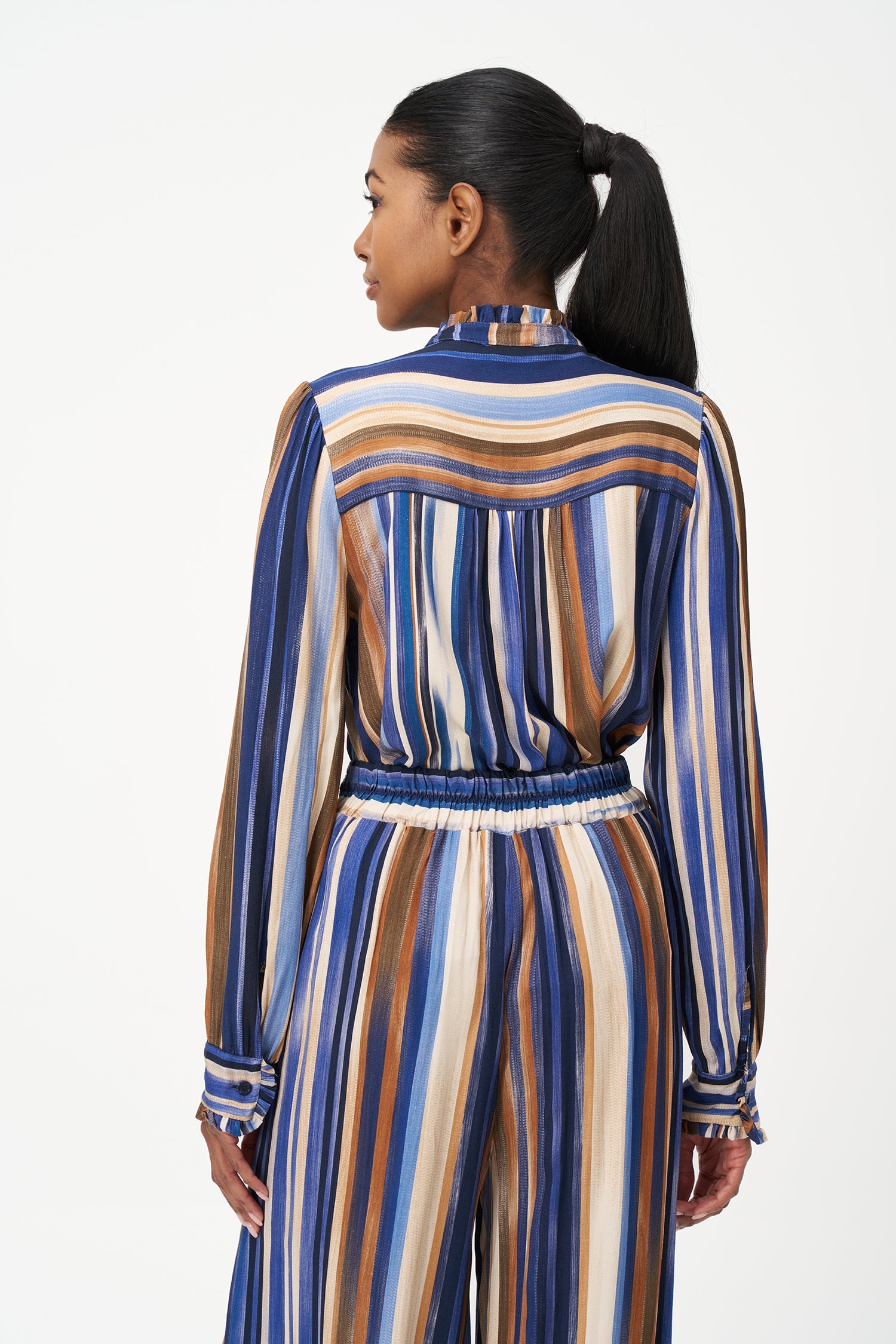 Women’s woven button-down shirt, with long set-in sleeves, a ruffled stand collar and ruffled cuffs