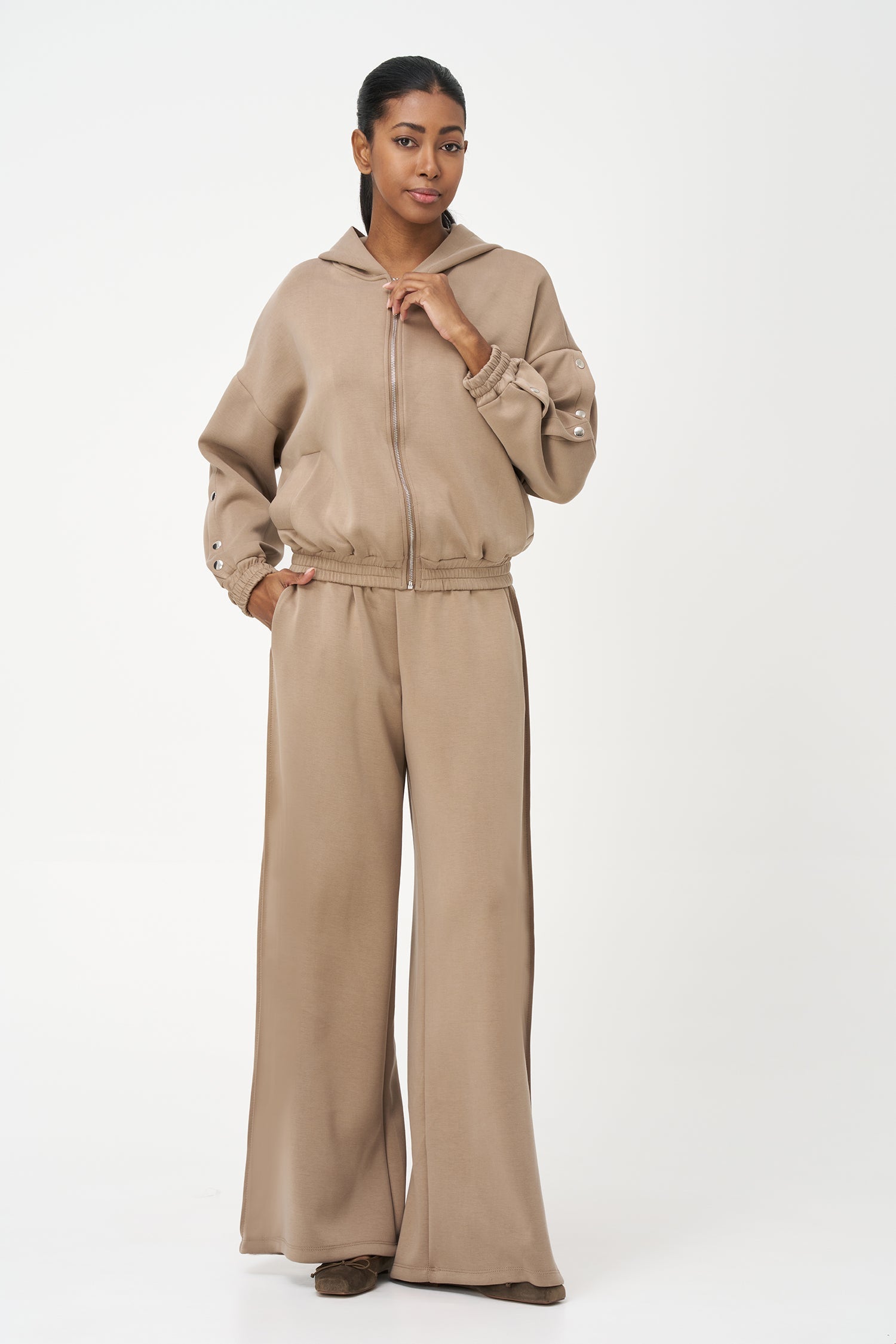 Women's knit hooded zip-up long sleeve sweatshirt, with stud detailing at the arms and front welt functional pockets