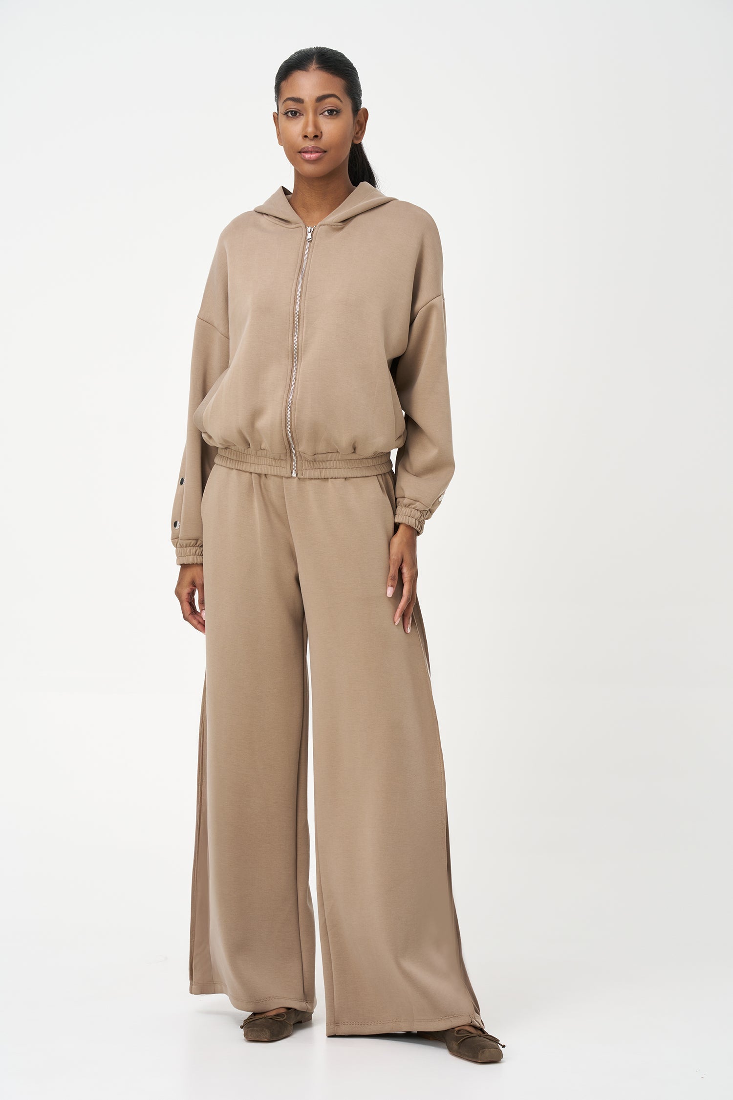 Women's knit hooded zip-up long sleeve sweatshirt, with stud detailing at the arms and front welt functional pockets