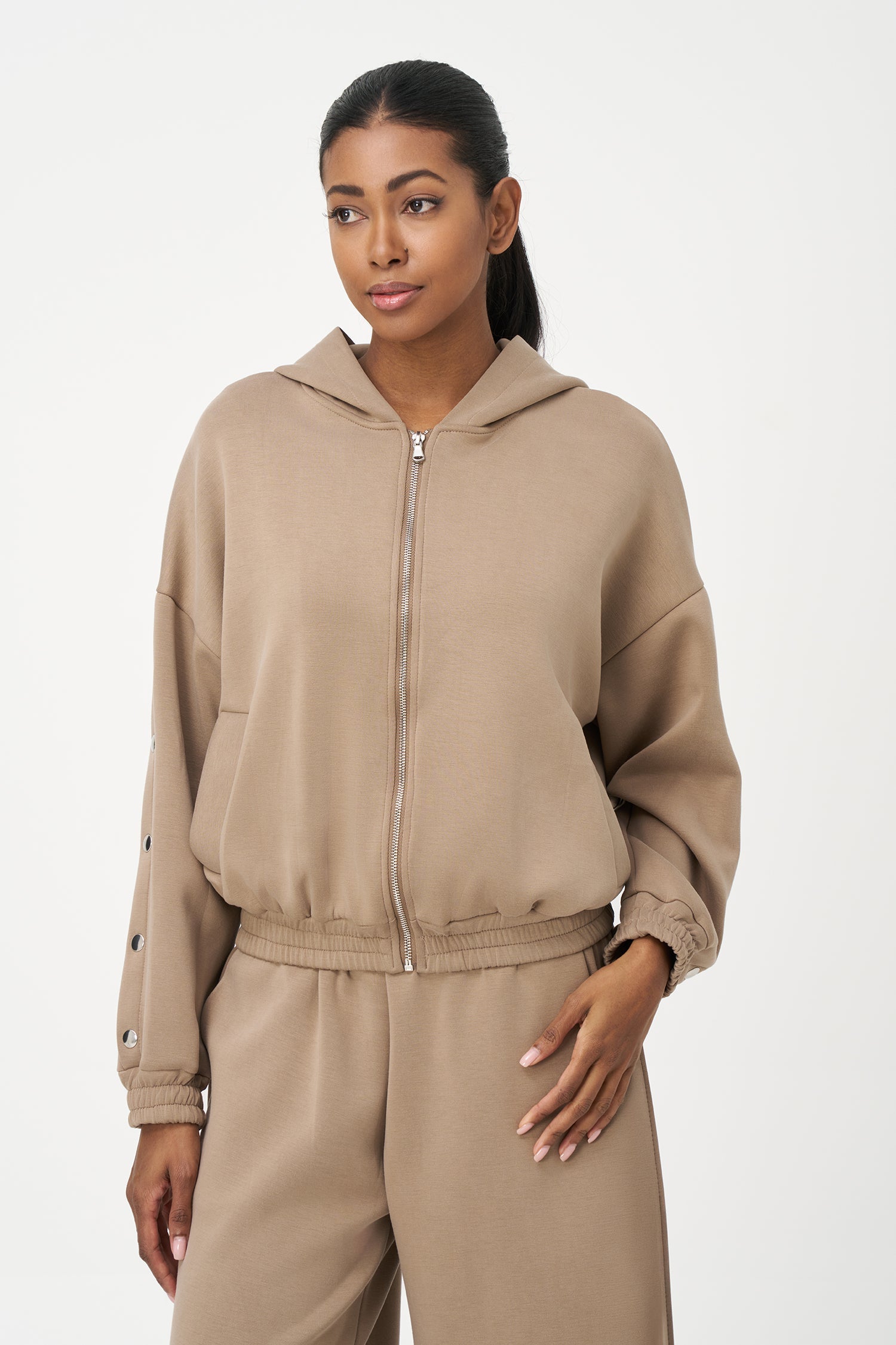 Women's knit hooded zip-up long sleeve sweatshirt, with stud detailing at the arms and front welt functional pockets