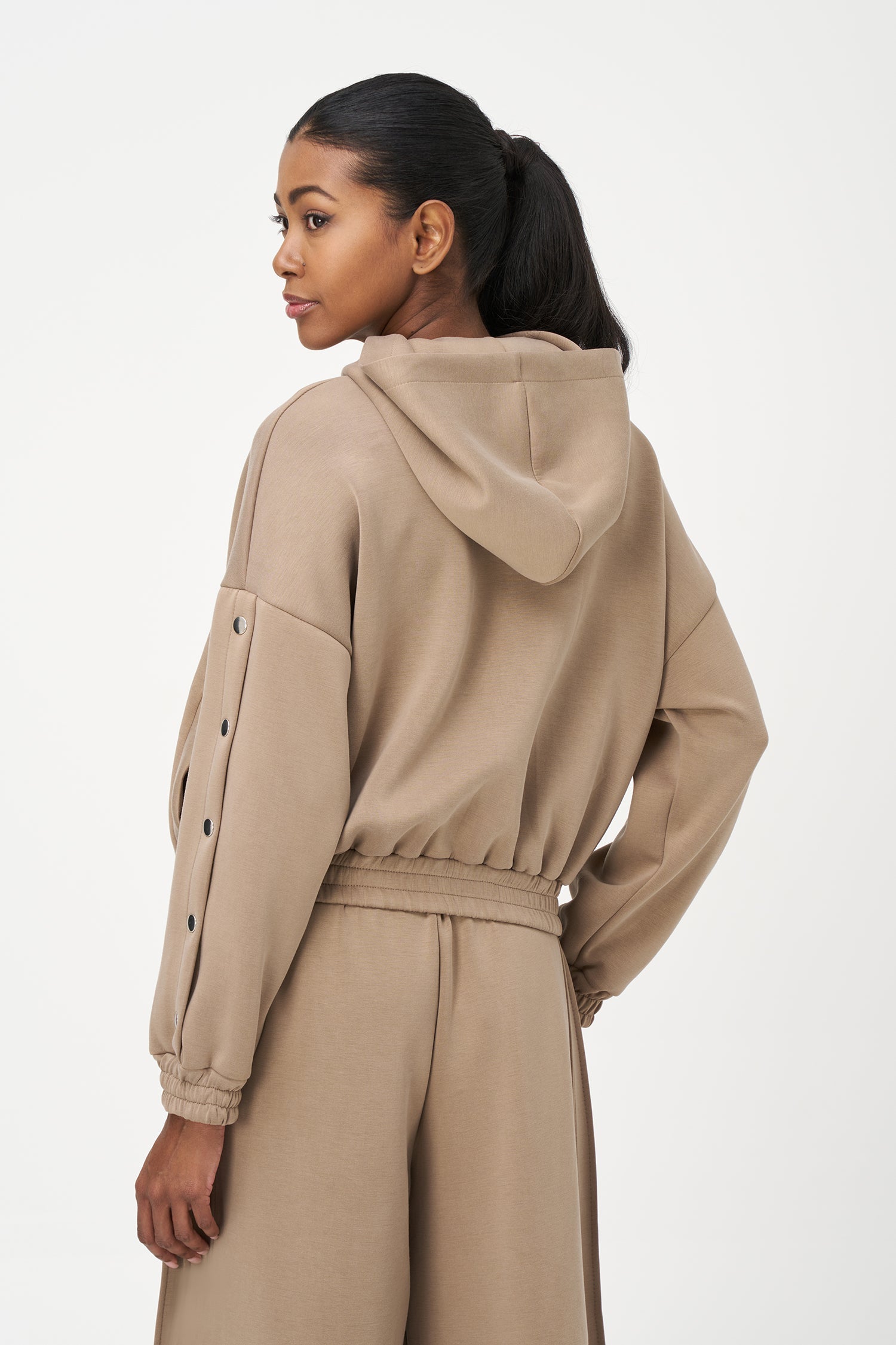 Women's knit hooded zip-up long sleeve sweatshirt, with stud detailing at the arms and front welt functional pockets