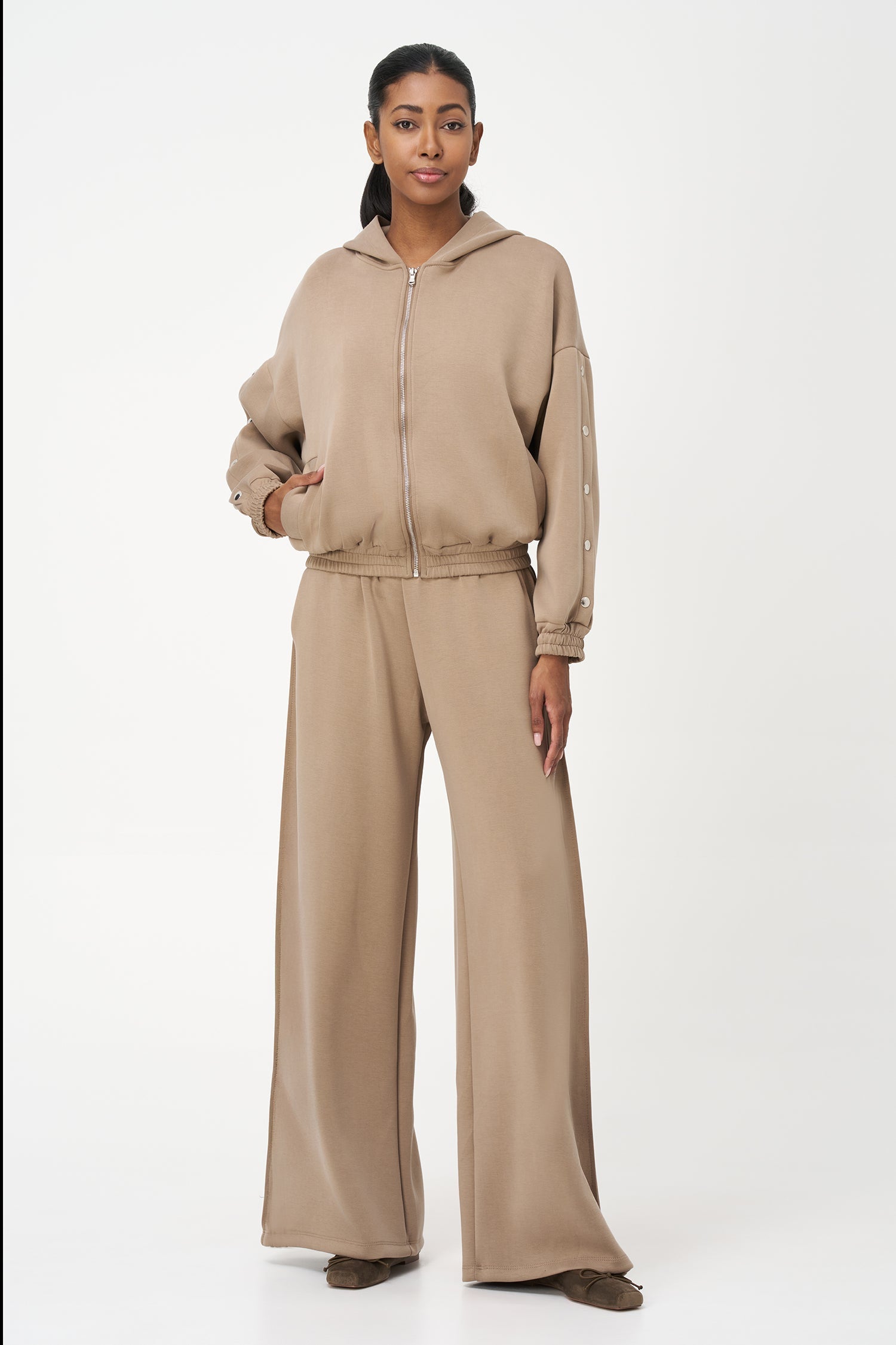 Women's knit hooded zip-up long sleeve sweatshirt, with stud detailing at the arms and front welt functional pockets