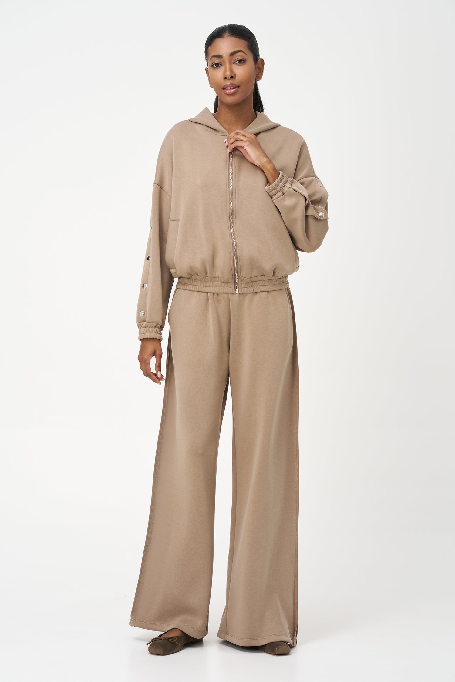 Women's knit hooded zip-up long sleeve sweatshirt, with stud detailing at the arms and front welt functional pockets