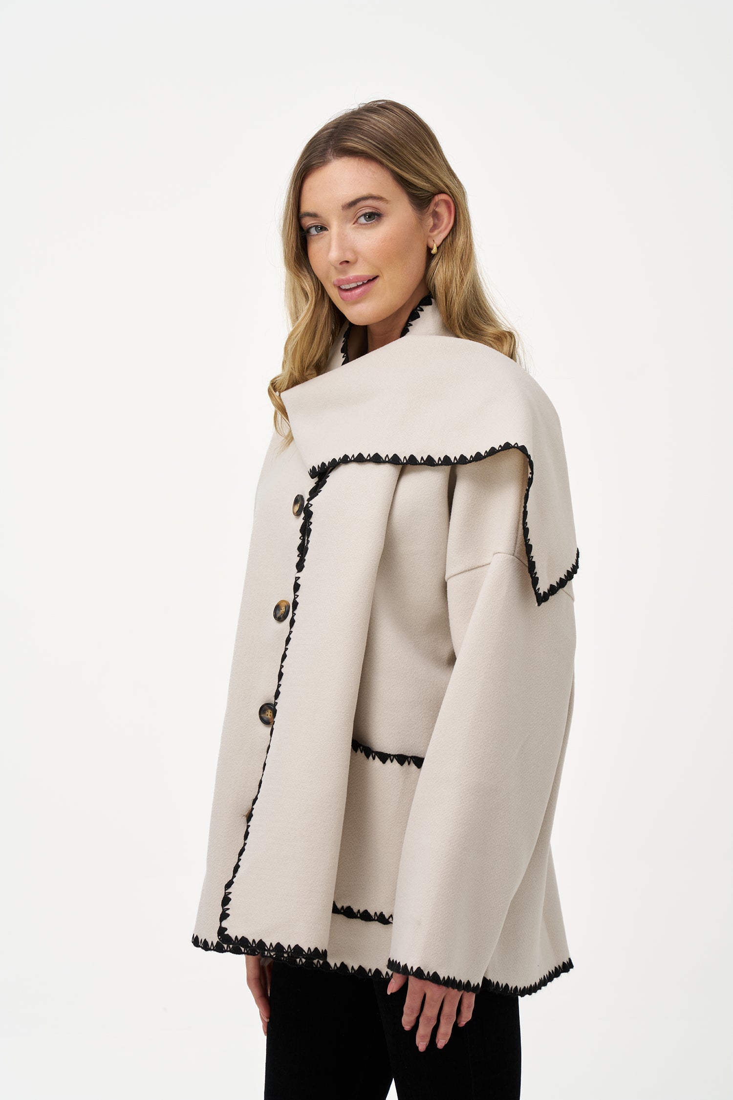Women's woven button-down hip-length coat, with decorative stitching, patch pockets, and a usable attached scarf