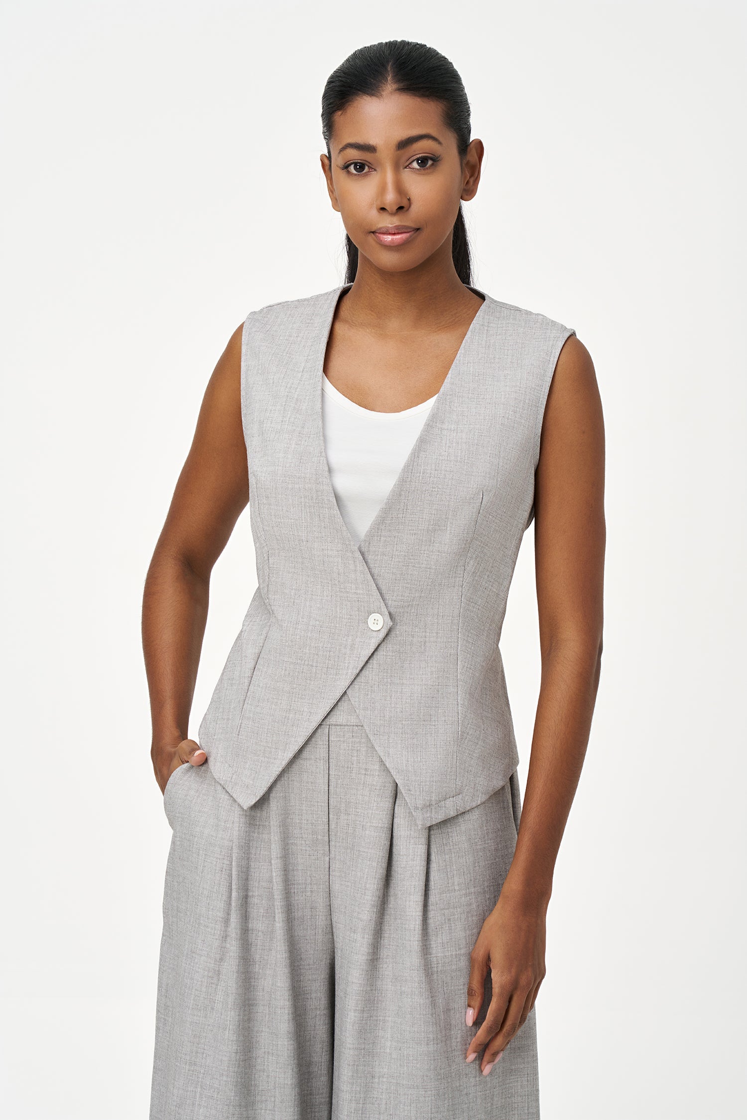 Women’s woven sleeveless vest with a v-neckline and a front button closure