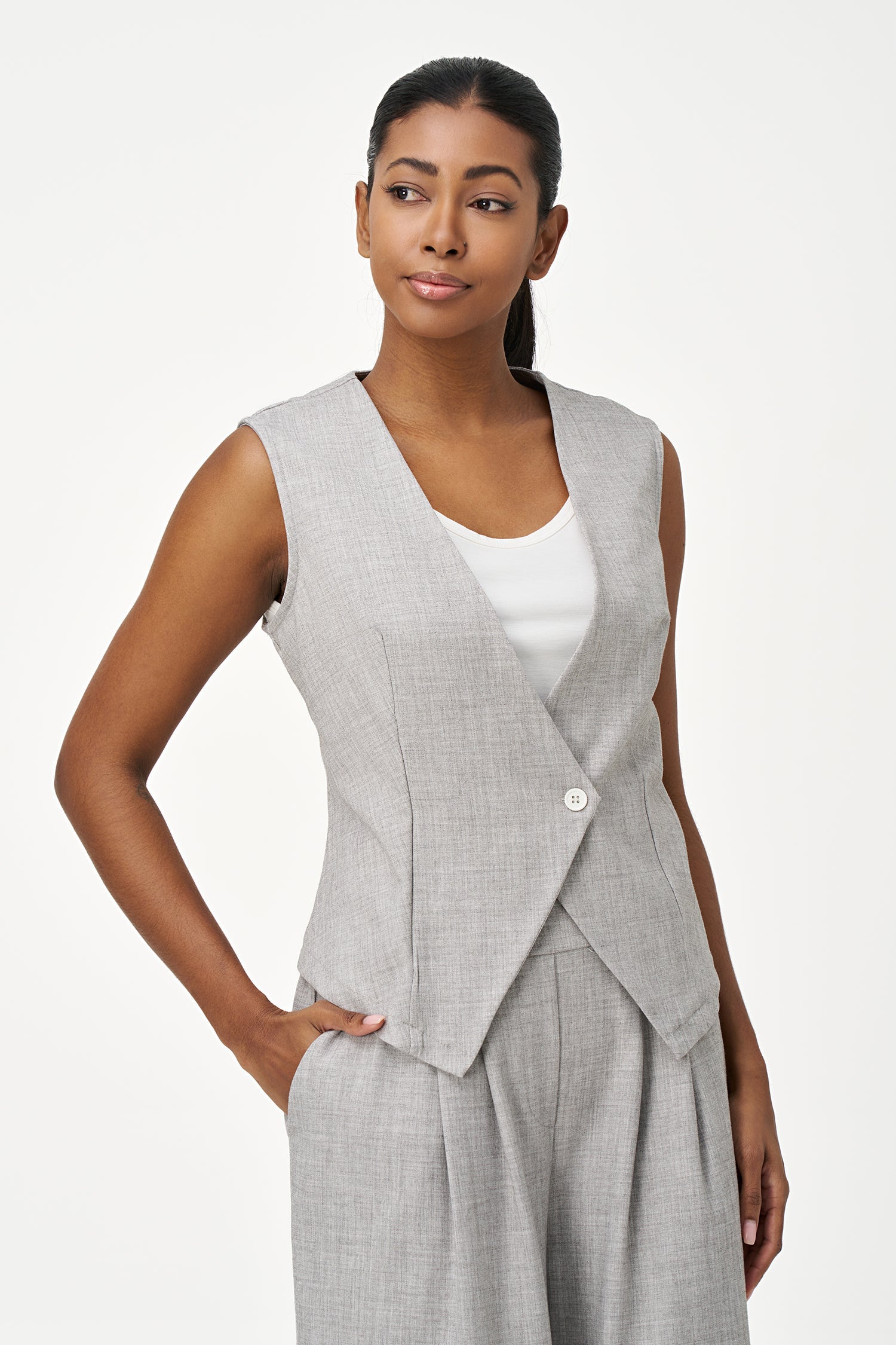 Women’s woven sleeveless vest with a v-neckline and a front button closure
