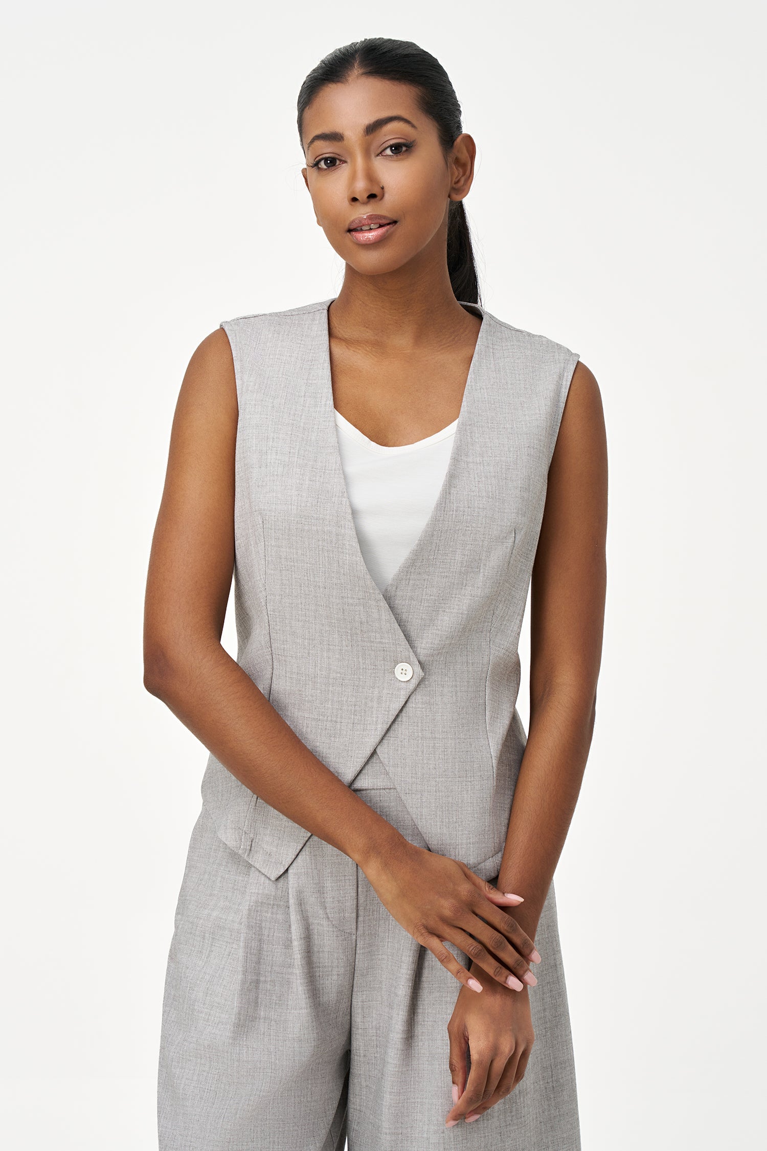 Women’s woven sleeveless vest with a v-neckline and a front button closure