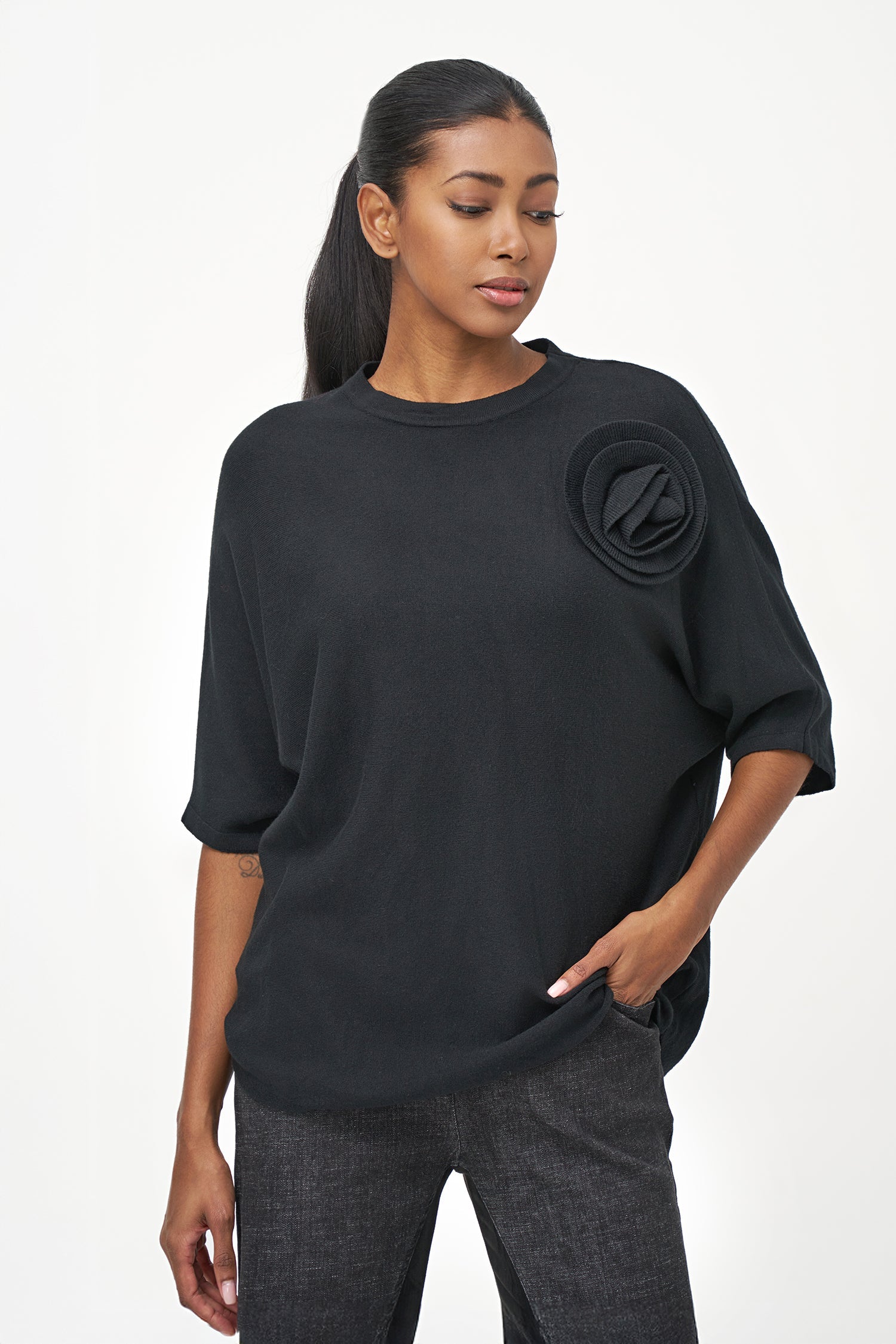 Women's knit short sleeve crew-neck sweater, with an attached flower detail
