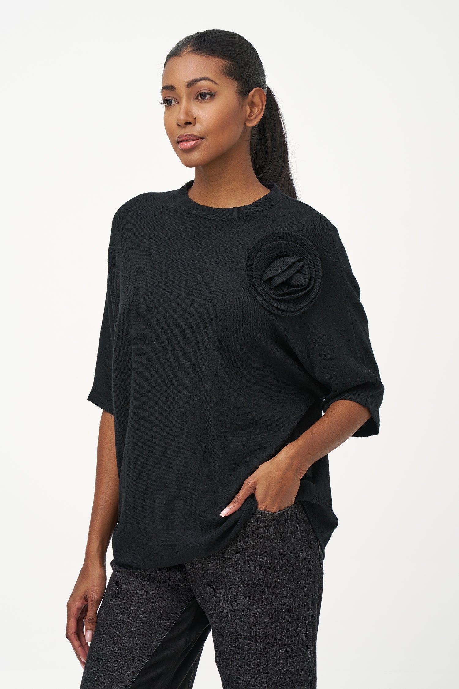 Women's knit short sleeve crew-neck sweater, with an attached flower detail