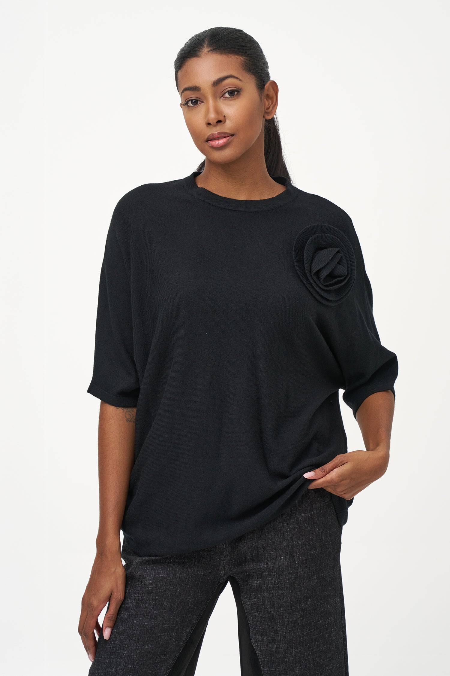 Women's knit short sleeve crew-neck sweater, with an attached flower detail