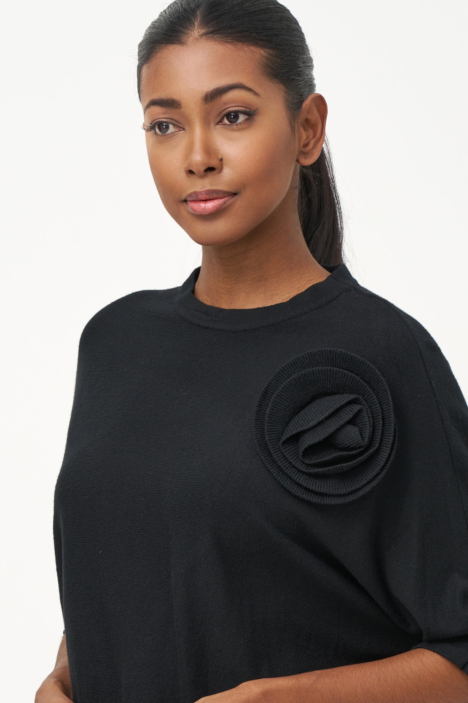 Women's knit short sleeve crew-neck sweater, with an attached flower detail