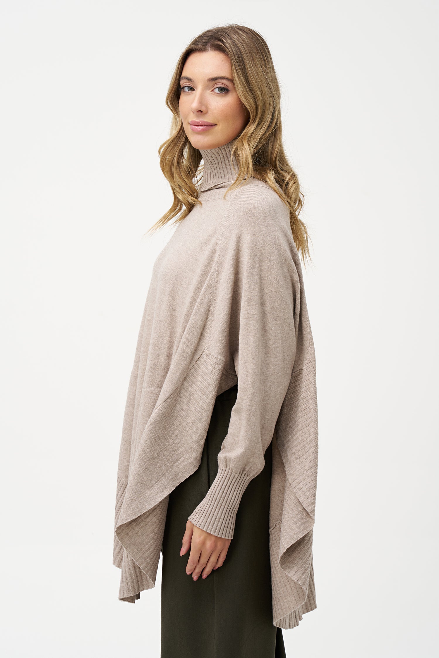 Women's knit oversized turtle-neck long sleeve sweater, with a scooped hemline