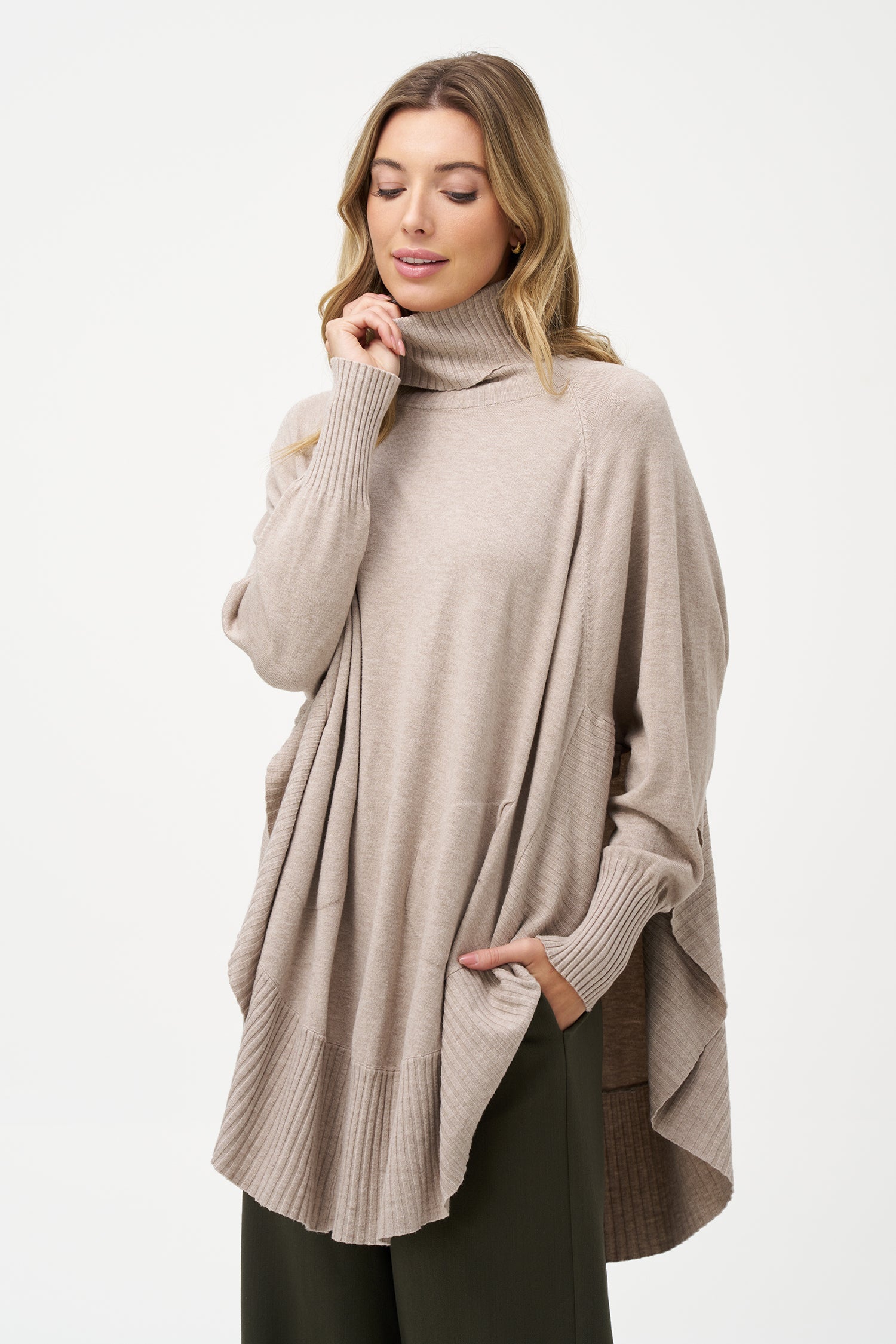 Women's knit oversized turtle-neck long sleeve sweater, with a scooped hemline