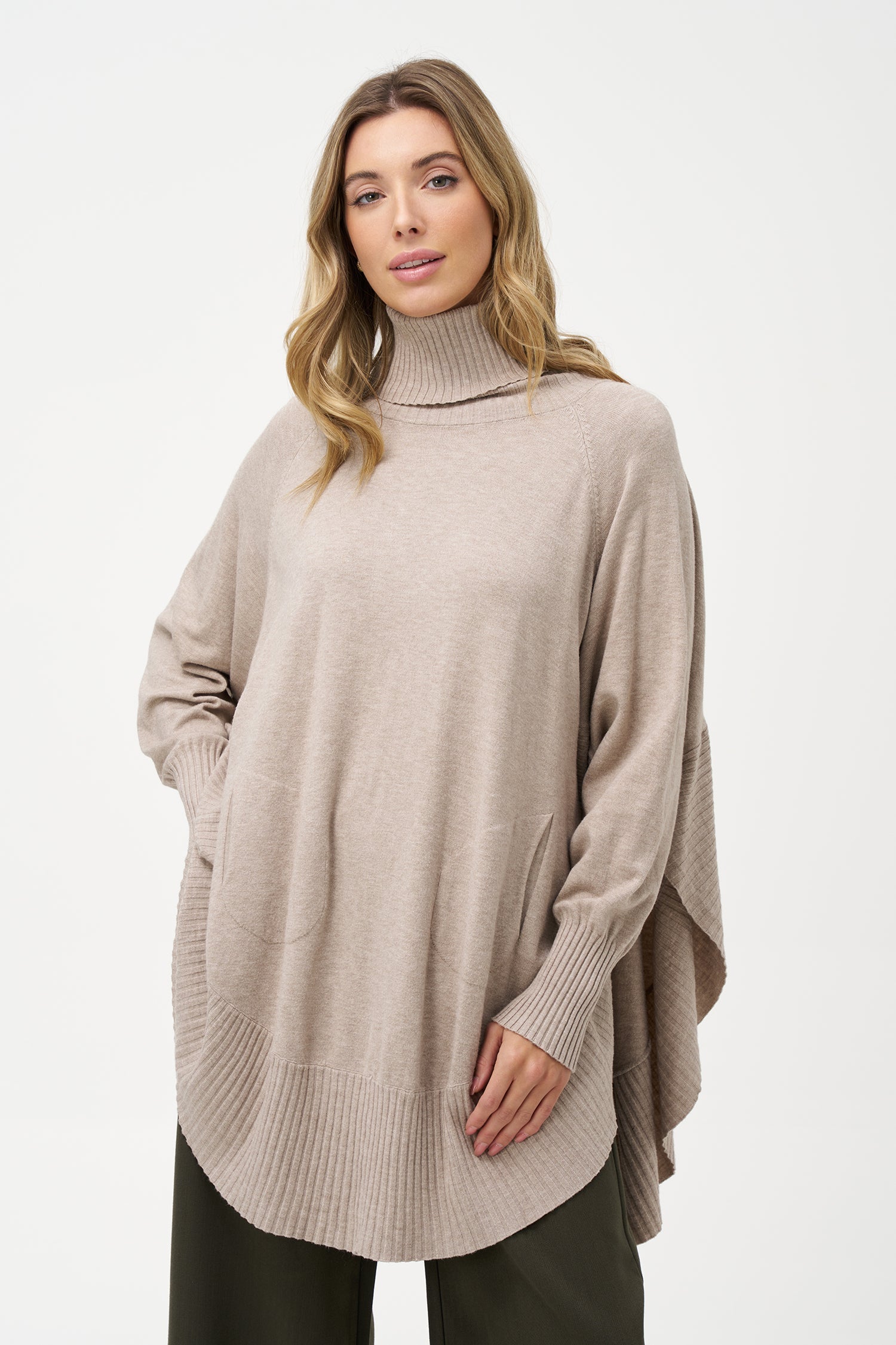 Women's knit oversized turtle-neck long sleeve sweater, with a scooped hemline