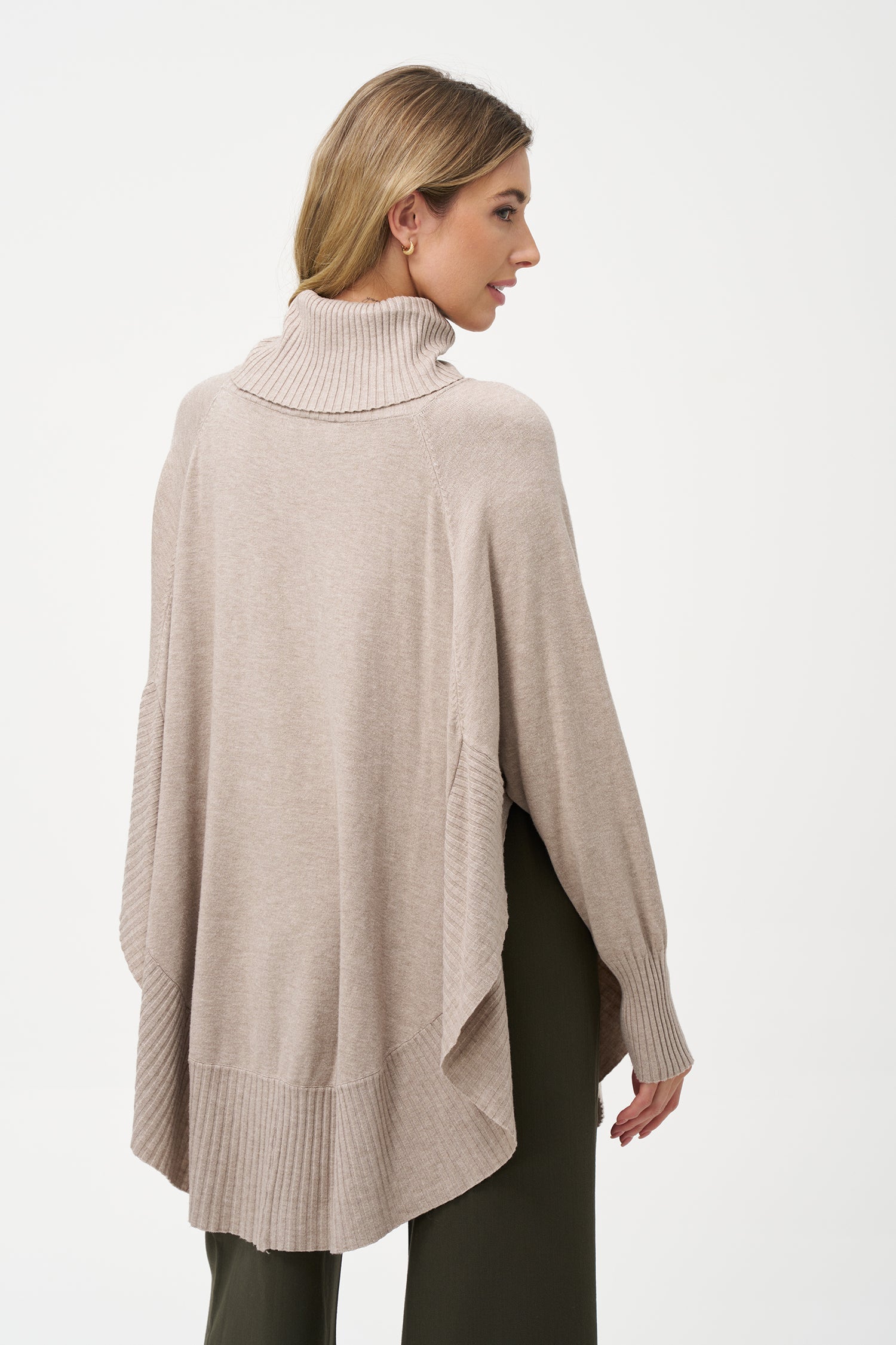 Women's knit oversized turtle-neck long sleeve sweater, with a scooped hemline