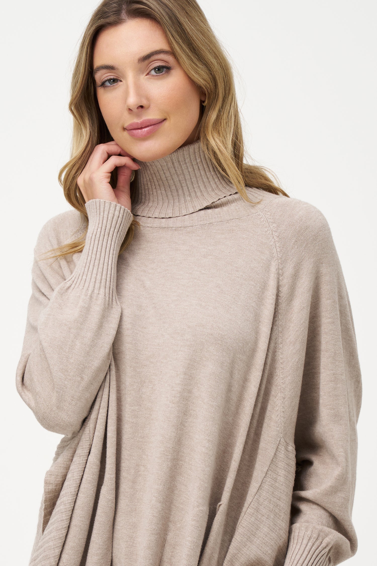 Women's knit oversized turtle-neck long sleeve sweater, with a scooped hemline