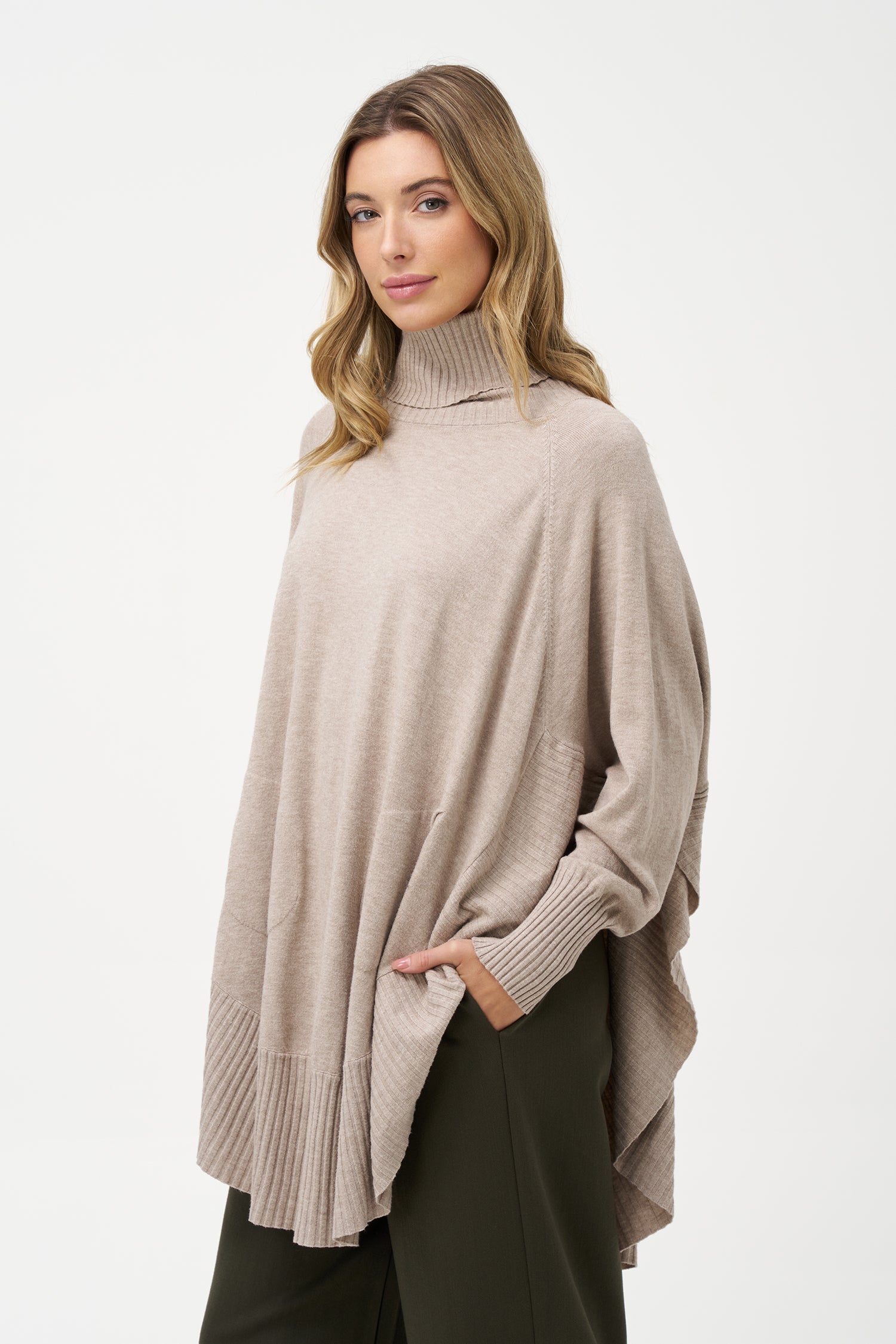 Women's knit oversized turtle-neck long sleeve sweater, with a scooped hemline