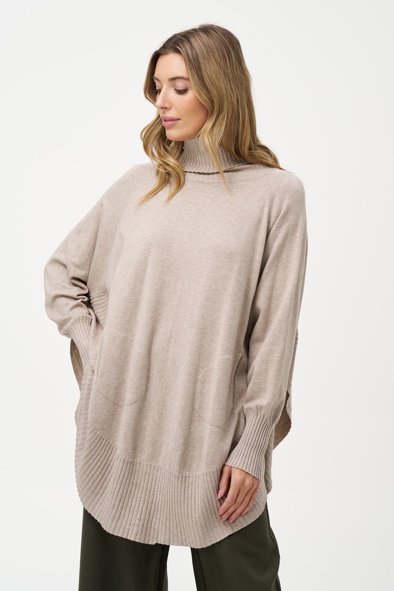 Women's knit oversized turtle-neck long sleeve sweater, with a scooped hemline