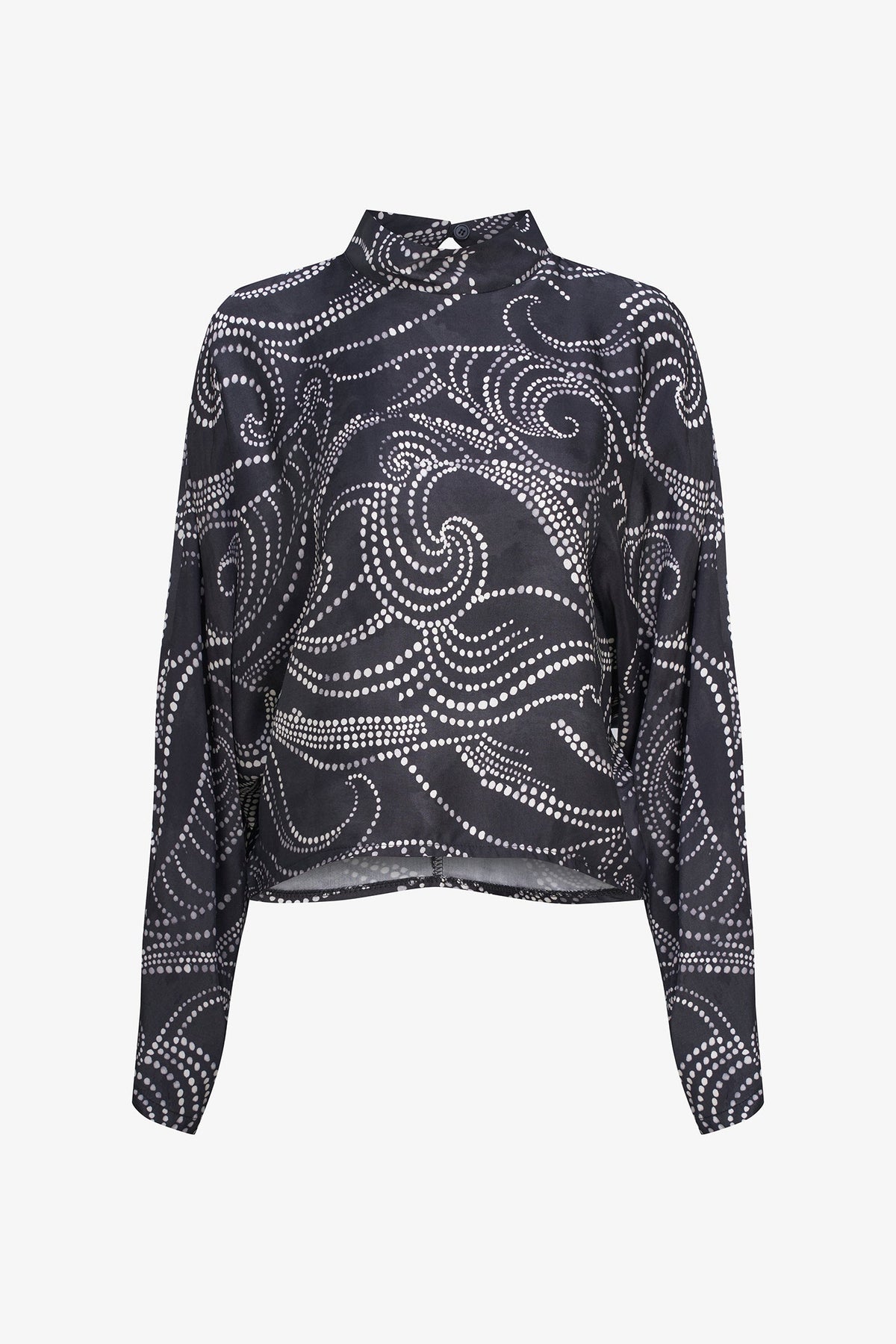 A long-sleeve high-neck blouse with a black base and a white dotted swirl pattern, displayed on a clean white background.