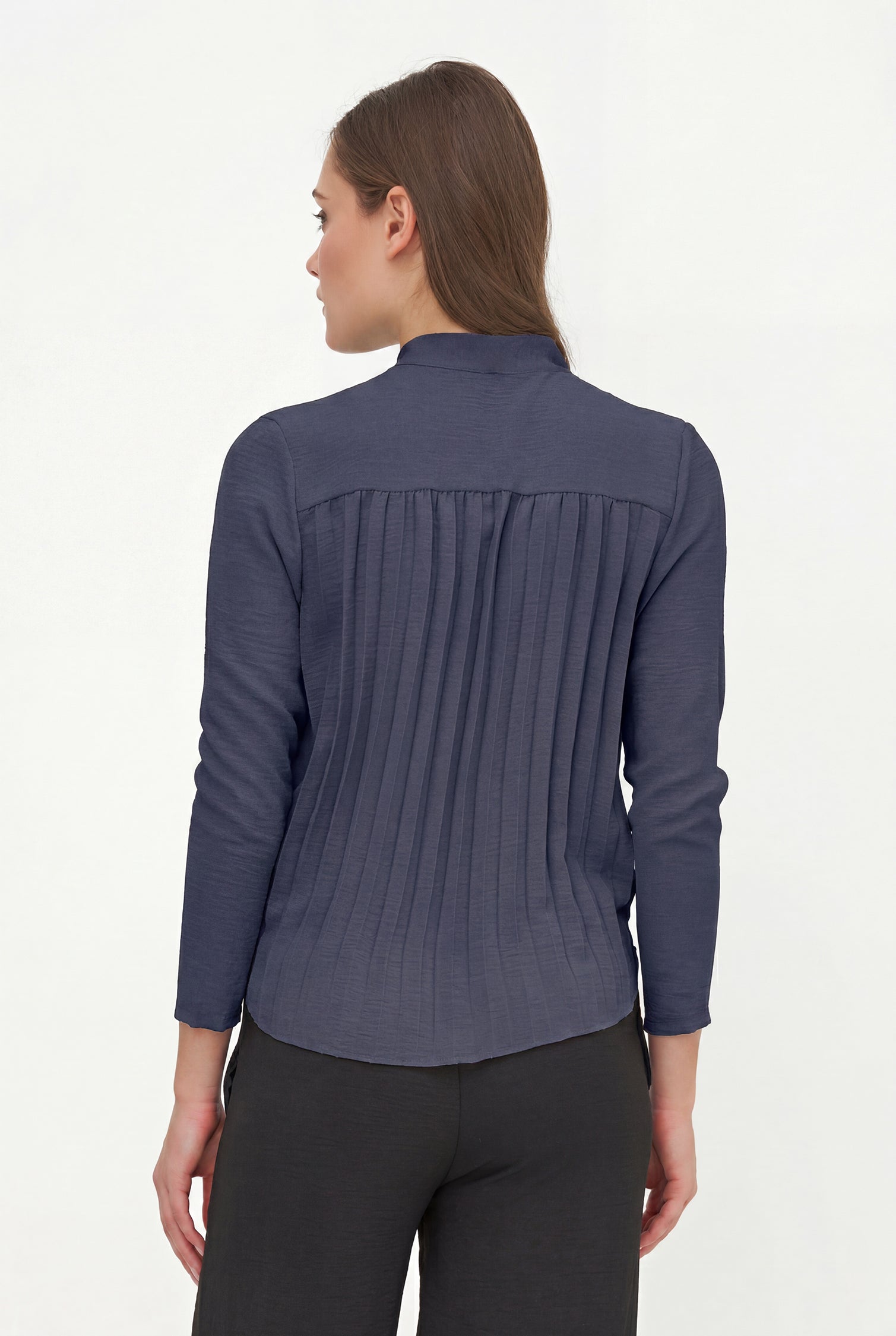 Woman wearing a blue long-sleeve shirt on a white background