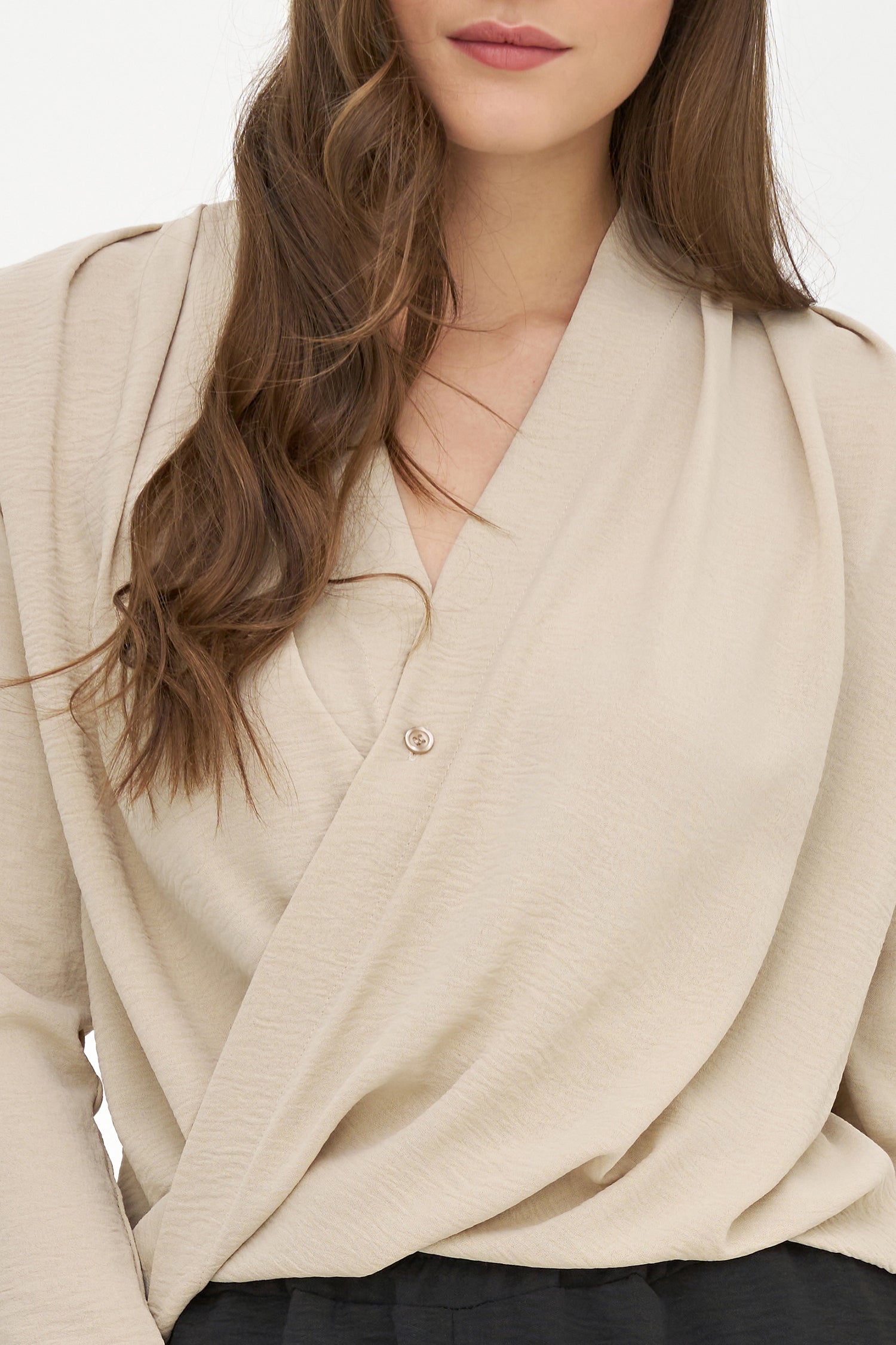 Beige cardigan worn by a person with a neutral background