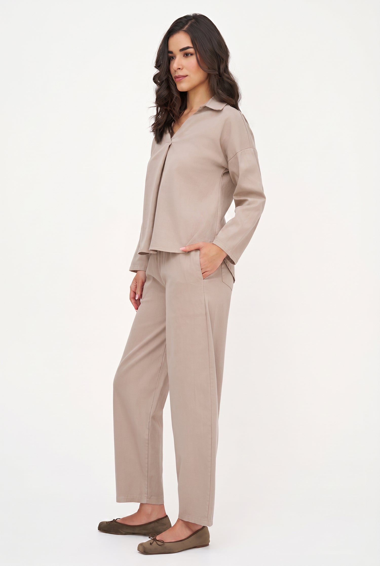 Woman wearing a beige suit on a white background